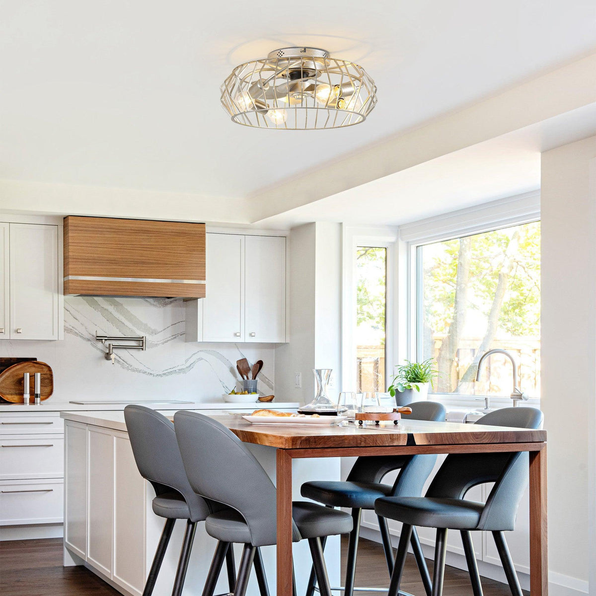 Silver flush mount ceiling fan with light in a wire cage, mounted on ceiling