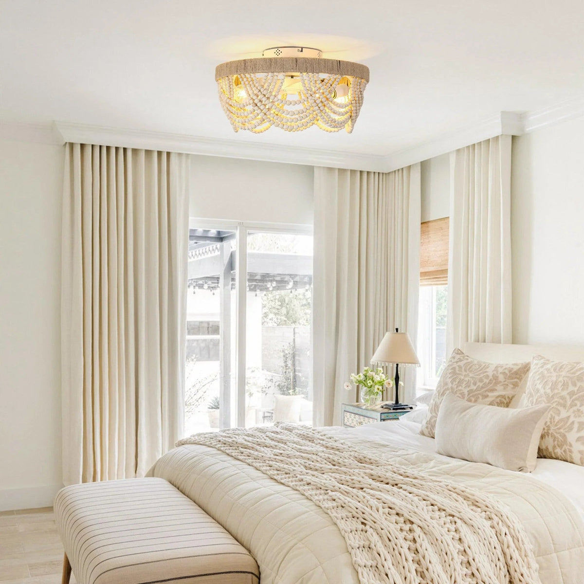 Wood-bead flush-mount ceiling fan with warm light bulbs above a bedroom