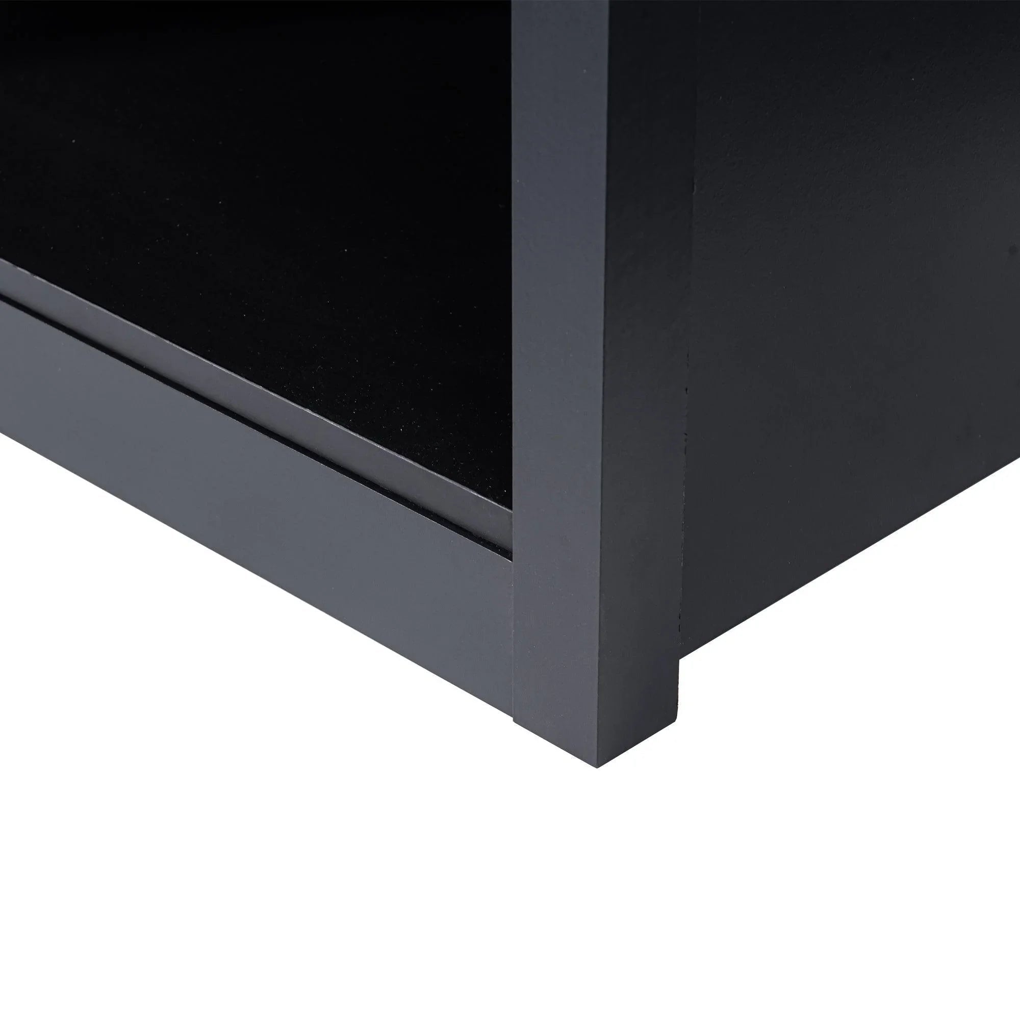 Black TV stand corner with low legs and smooth angled base