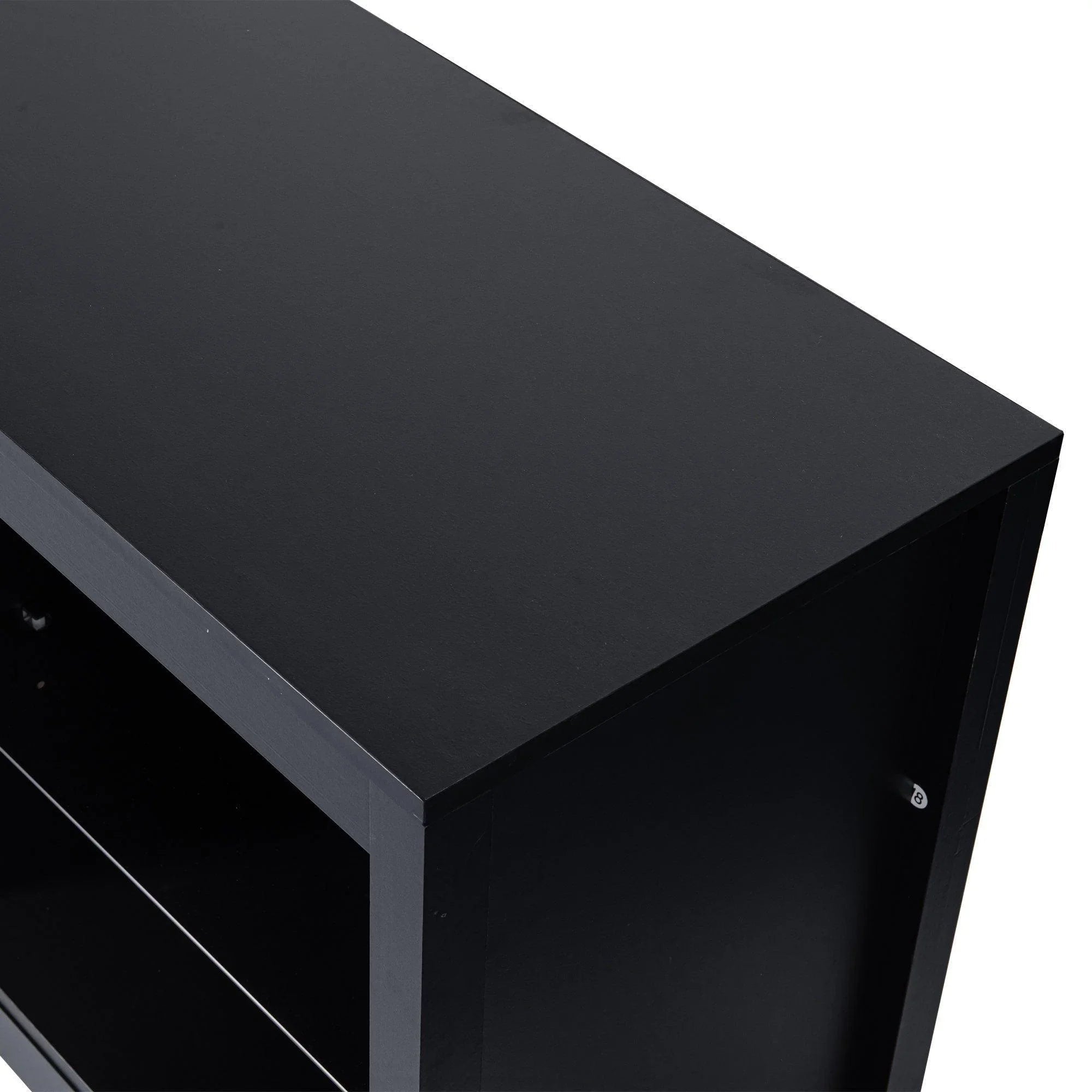 Black modern TV stand with open shelves and slanted edge top