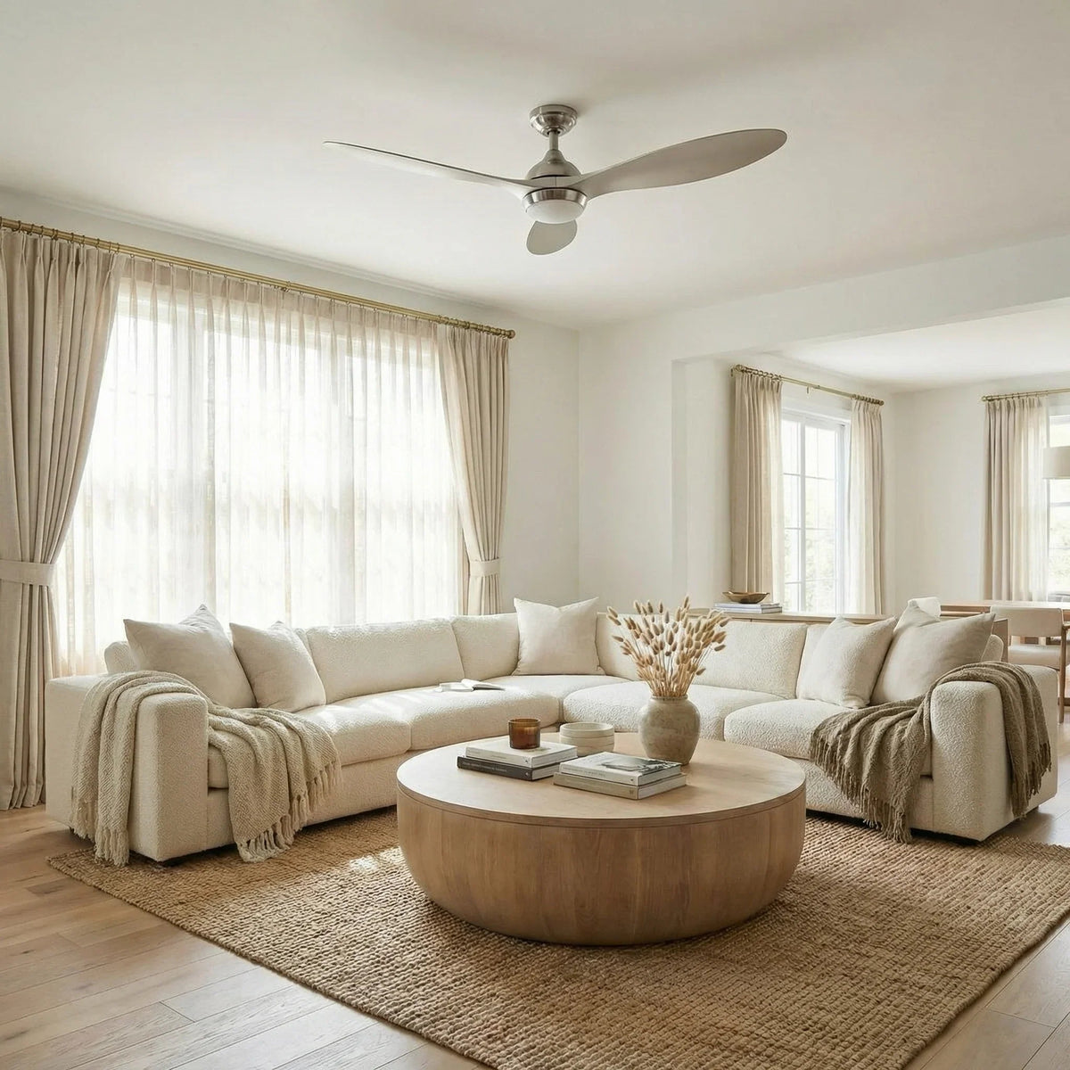 Brushed nickel ceiling fan with light mounted over living room seating