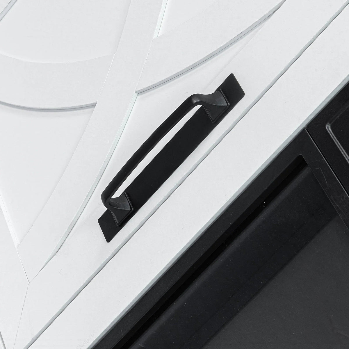 White cabinet door with curved farmhouse panel and black bar handle