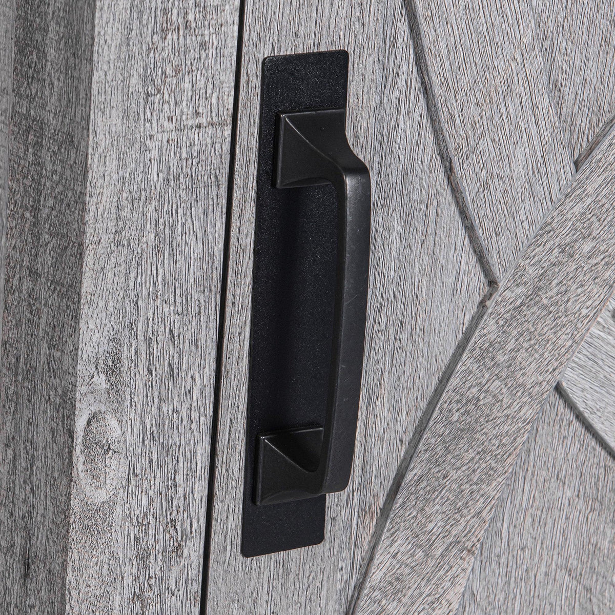 Black bar pull handle on gray wood nightstand cabinet door