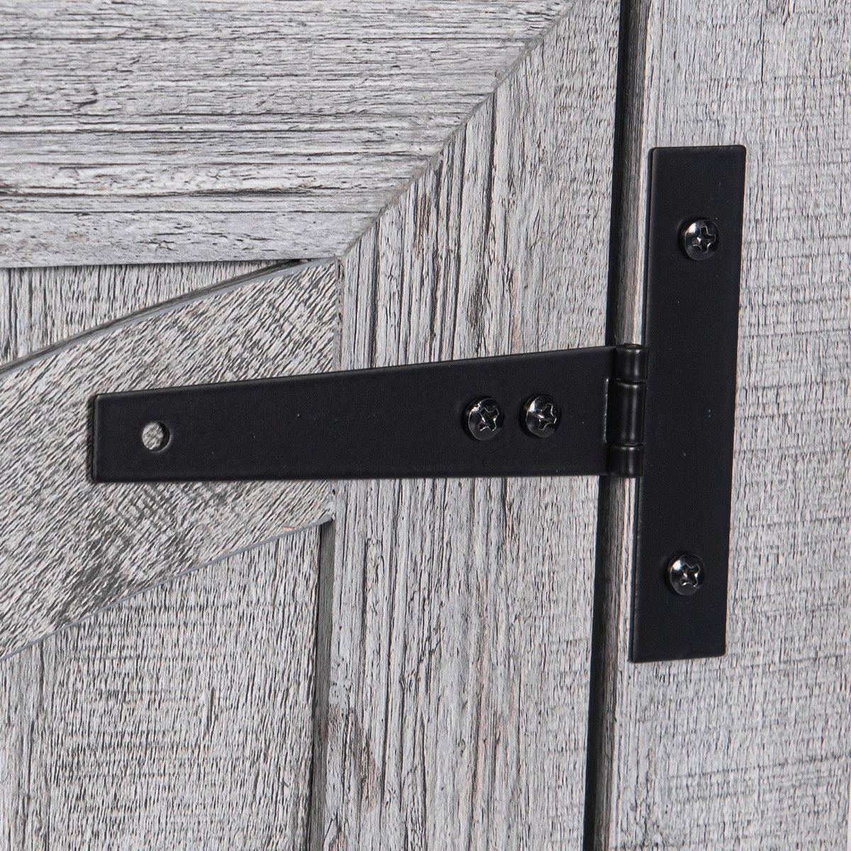 Black metal hinge on gray wood nightstand door