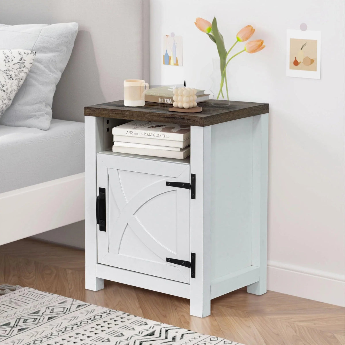 White farmhouse nightstand with cabinet door and top shelf holding small decor items
