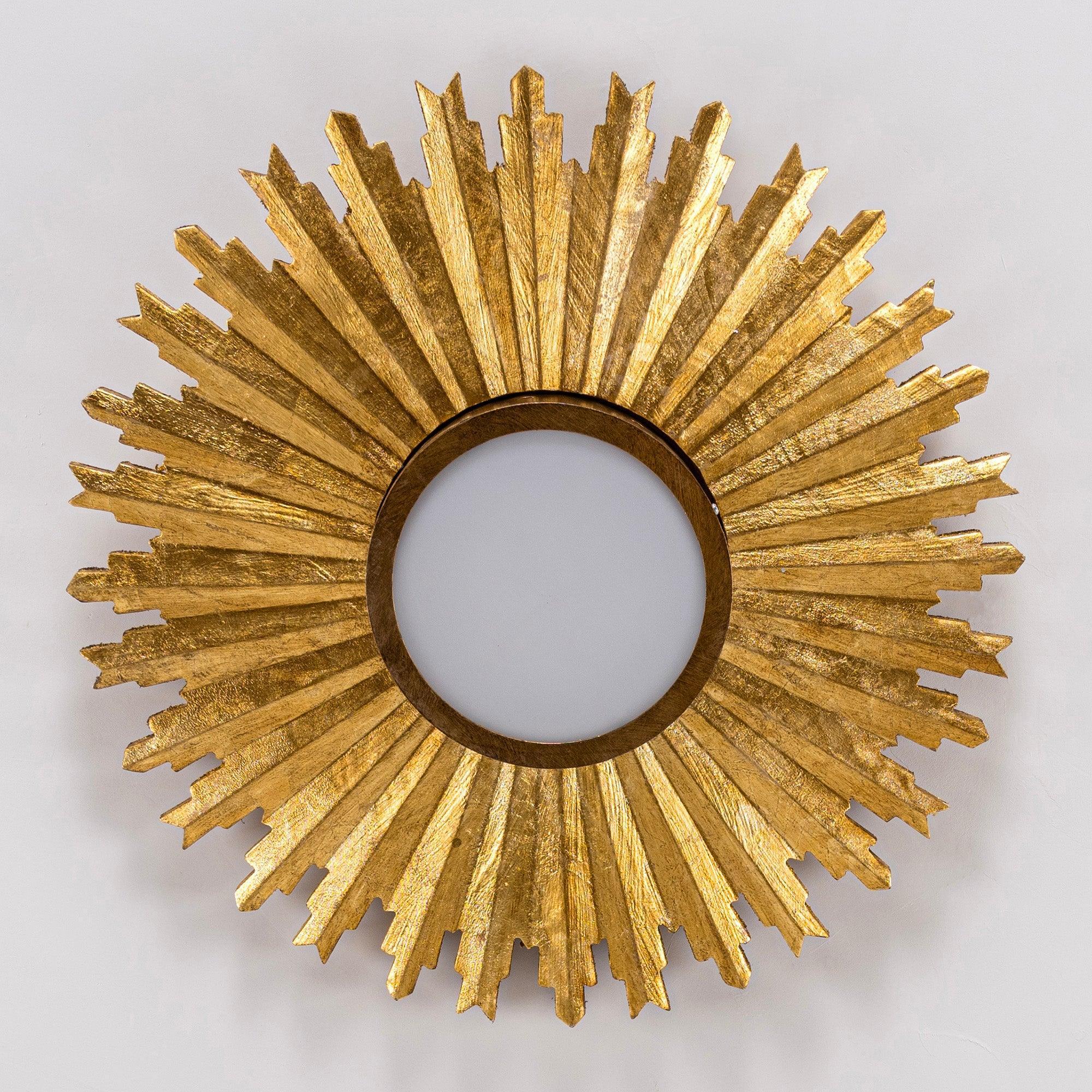Golden sunburst flush mount ceiling light with dark circular base and glass center