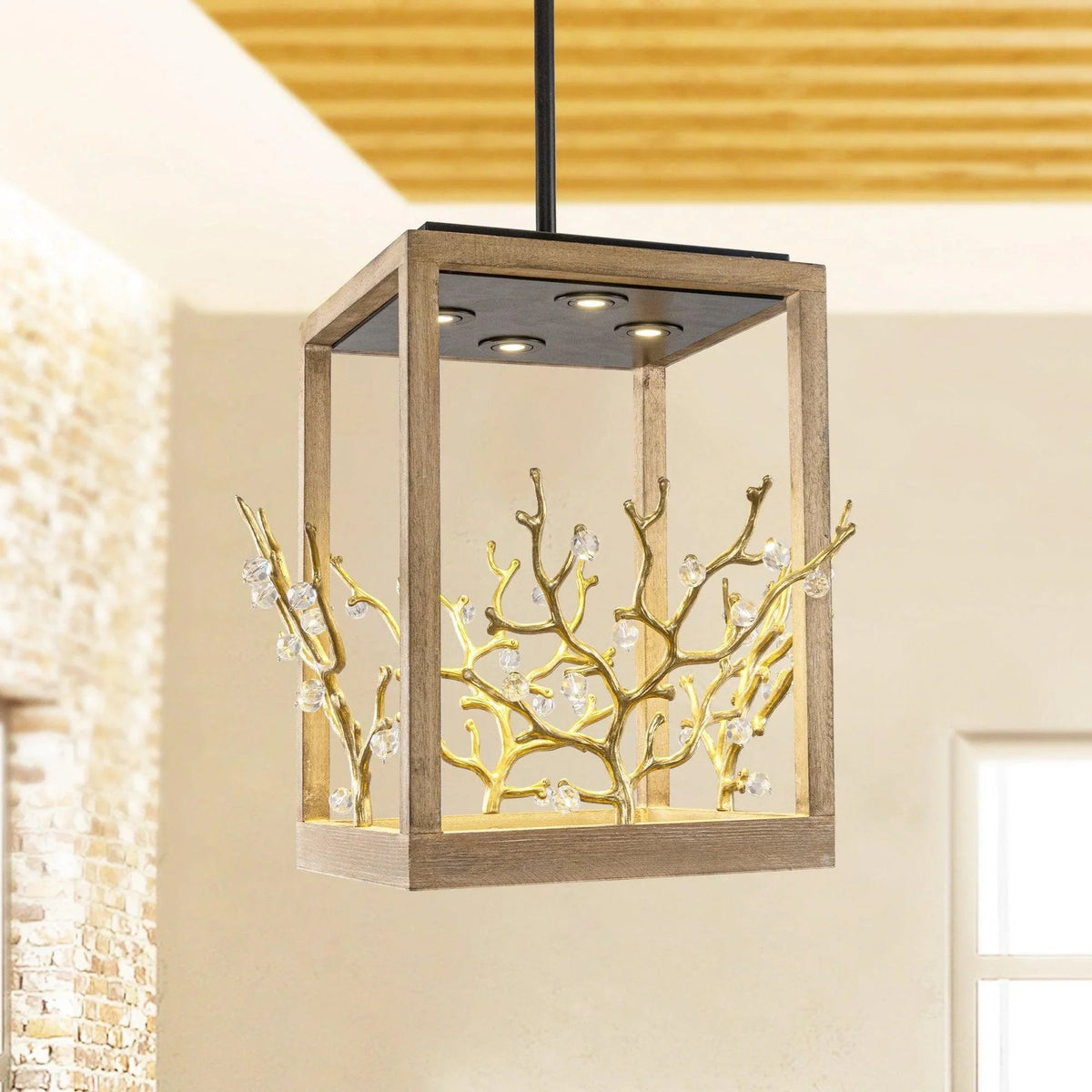 Golden branch pendant light with clear glass panels and glowing bulbs inside