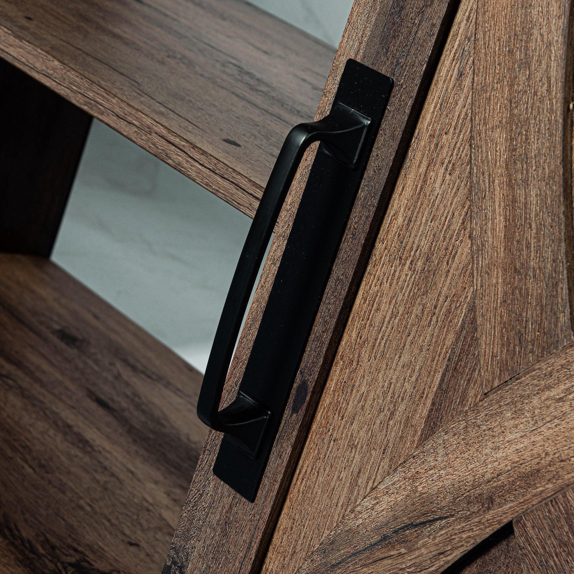 Black sliding door handle on brown farmhouse TV stand frame, side view