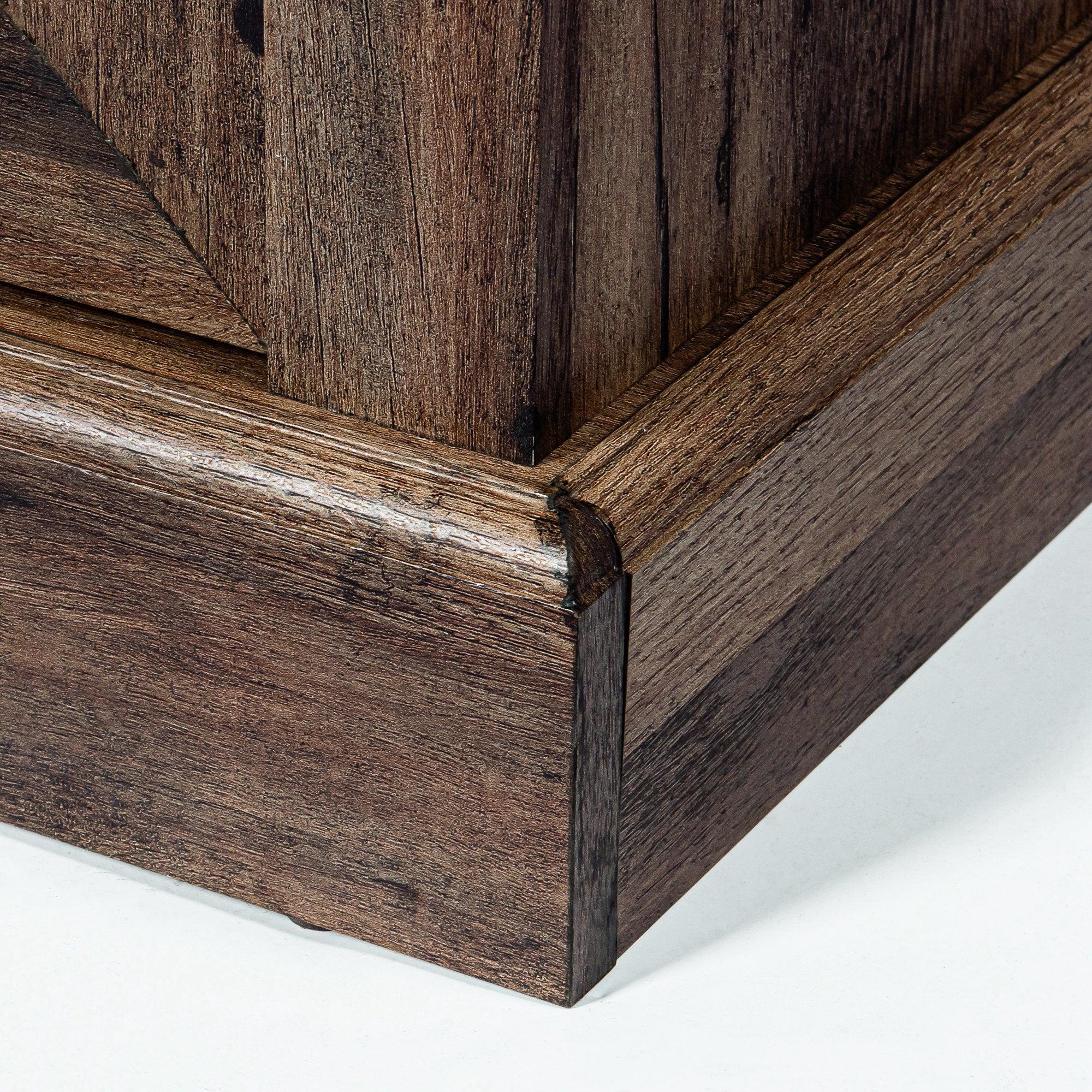 Corner detail of dark wood TV stand base with rustic board edges