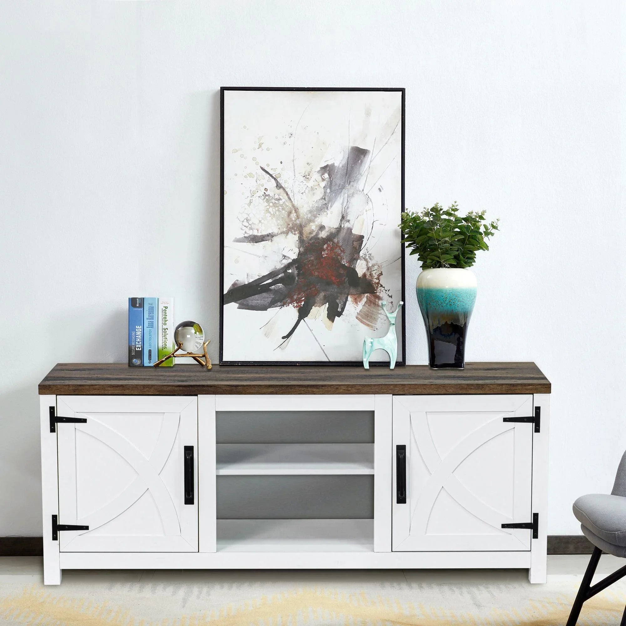 White TV stand with two cabinet doors, open center shelf, and dark top panel