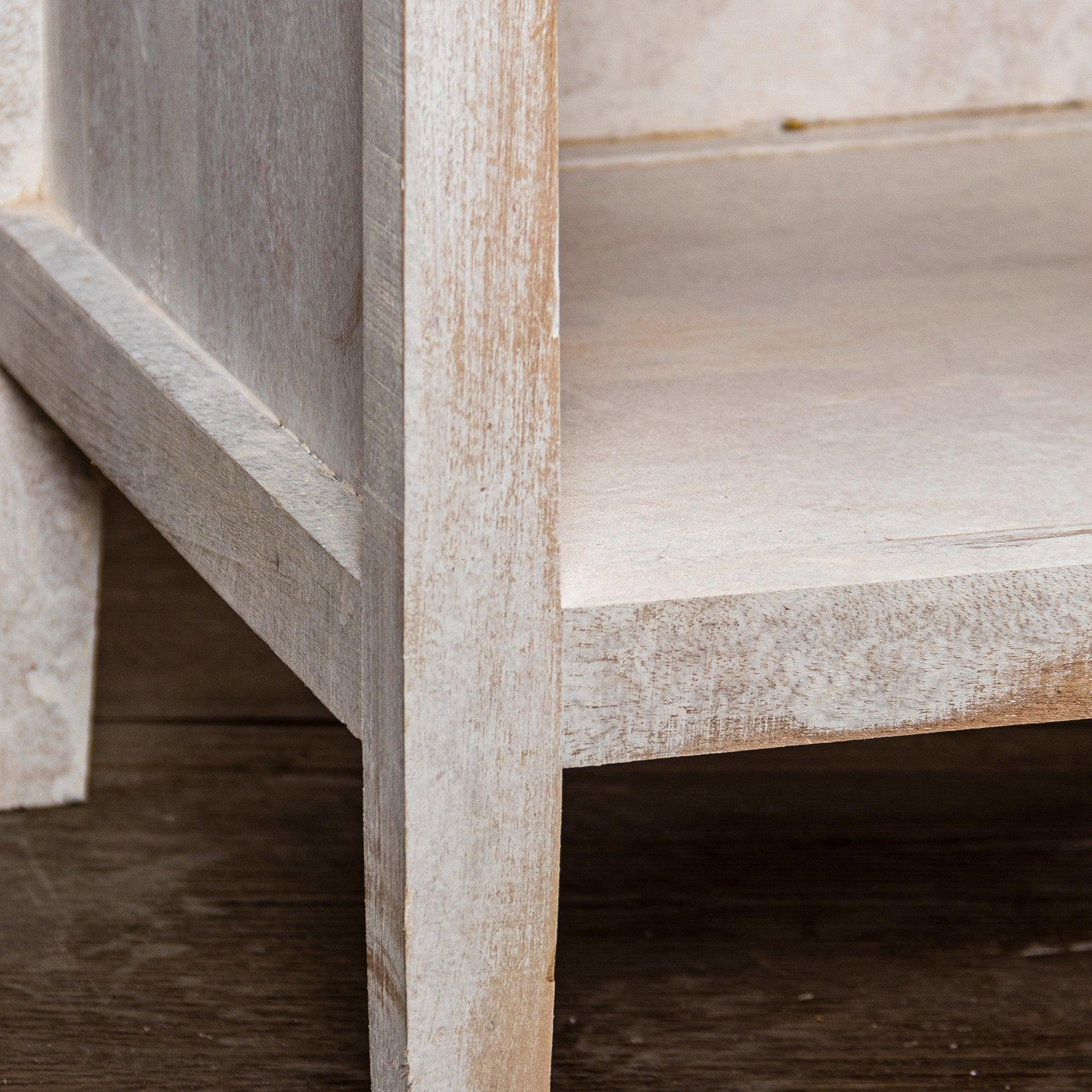 White nightstand showing open drawer and side frame detail