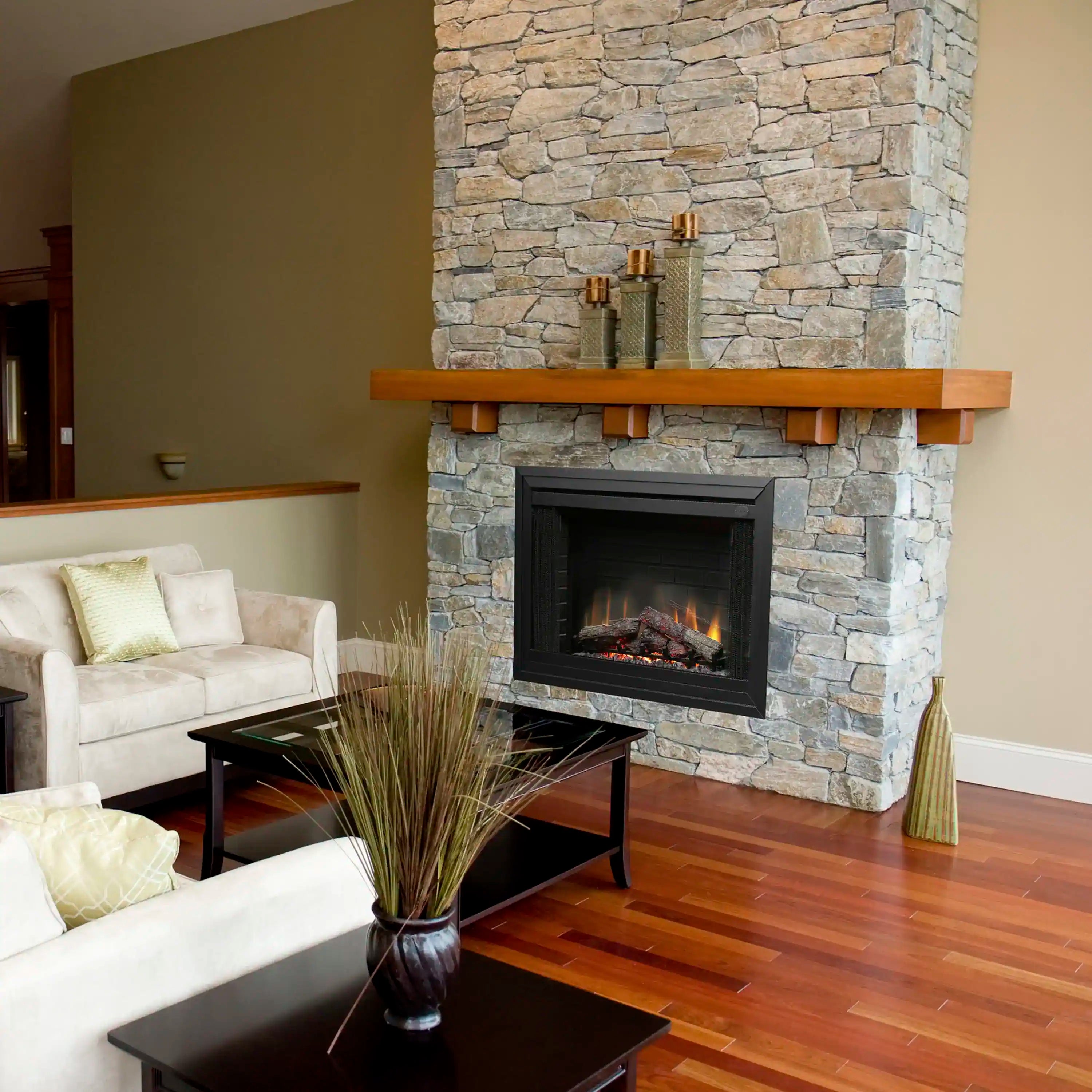 Built-in electric fireplace insert set in a gray stone surround with flame display