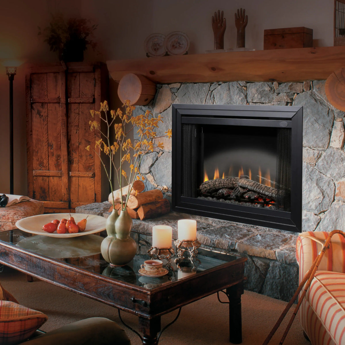 Electric fireplace insert in stone surround with black frame and flame effect logs