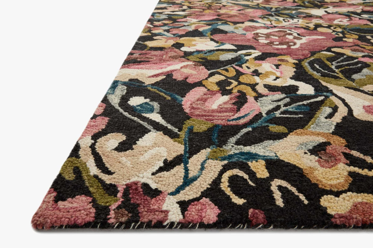 Accent rug with ivory, raspberry, black, and blue floral-inspired pattern, textured pile.