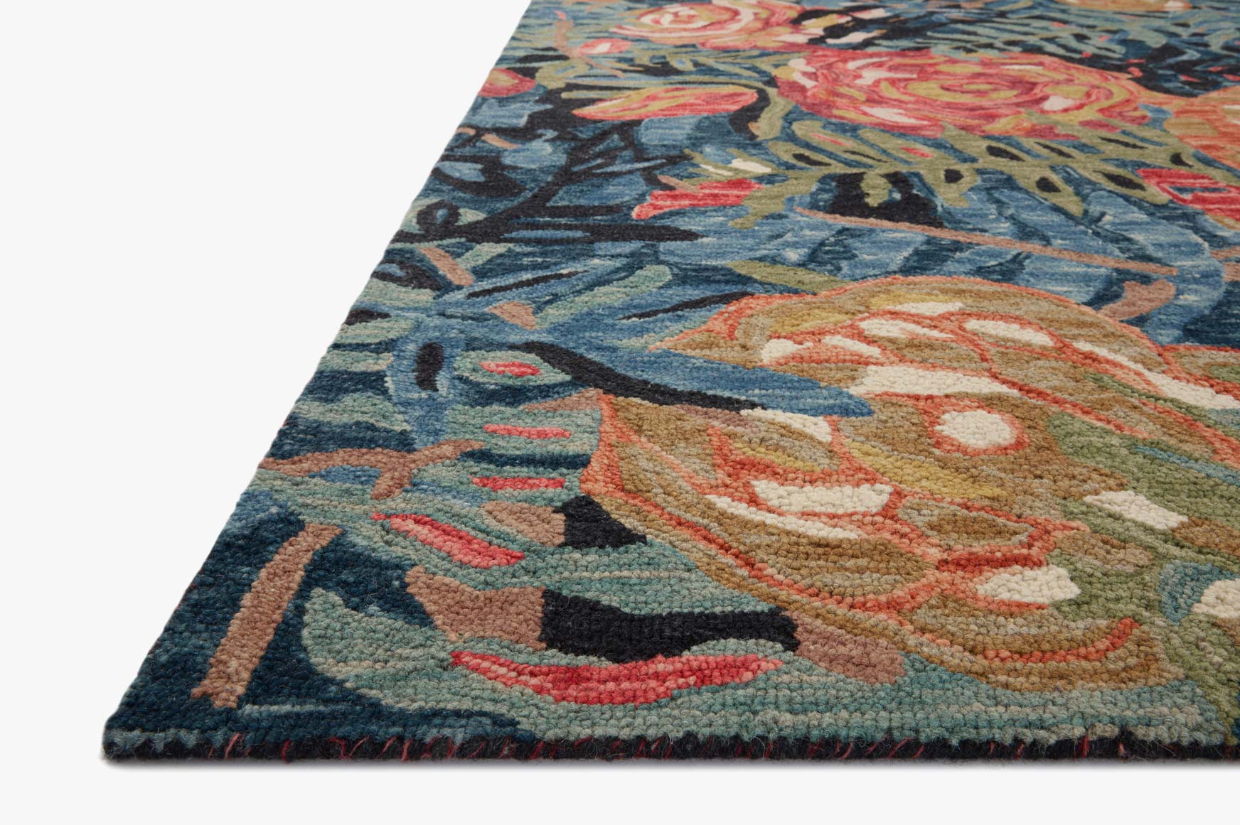 Accent rug with bold floral medallion pattern in dark blue/black, teal, coral, and gold.