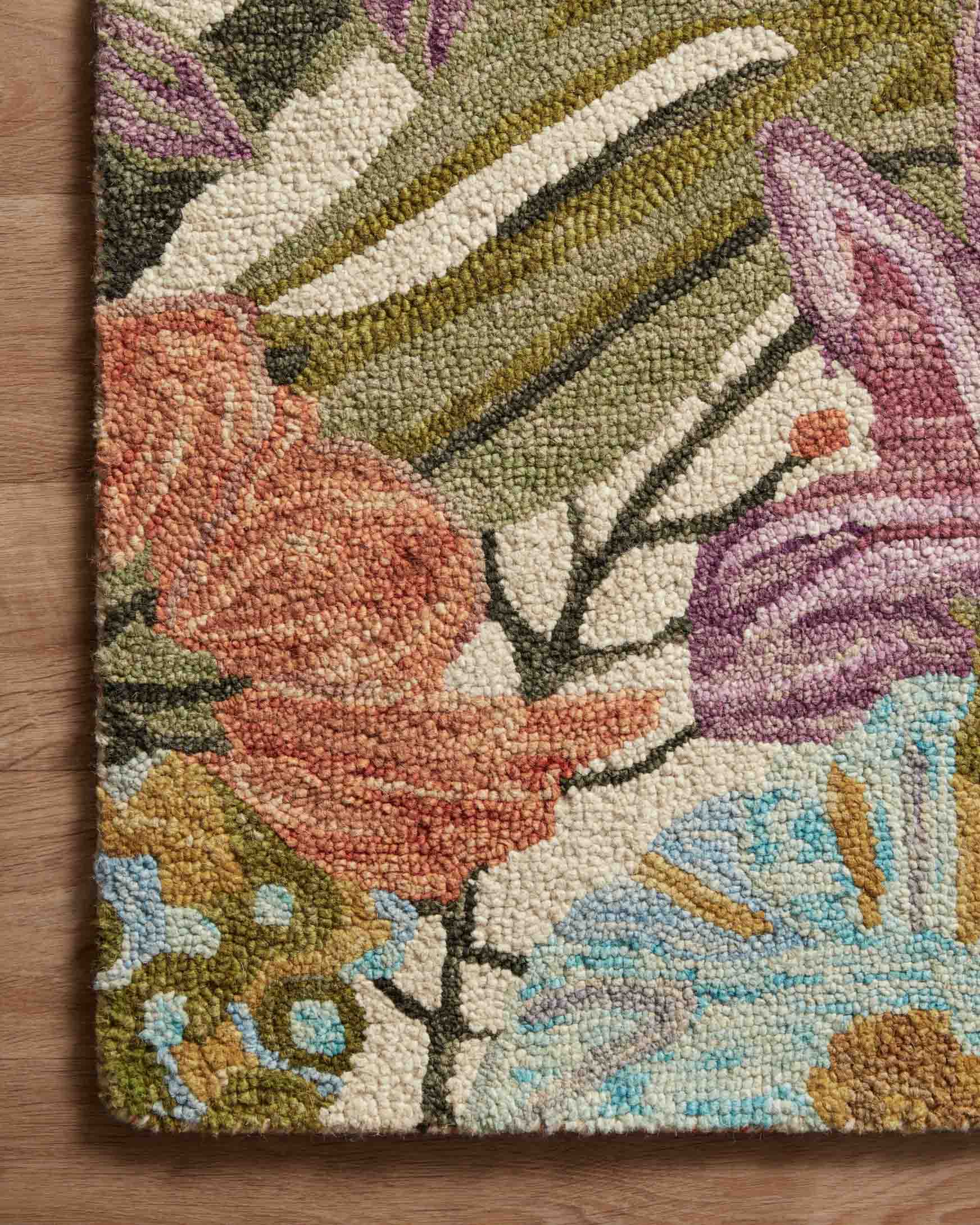 Multicolor floral area rug corner close-up with textured hooked pile and ivory base