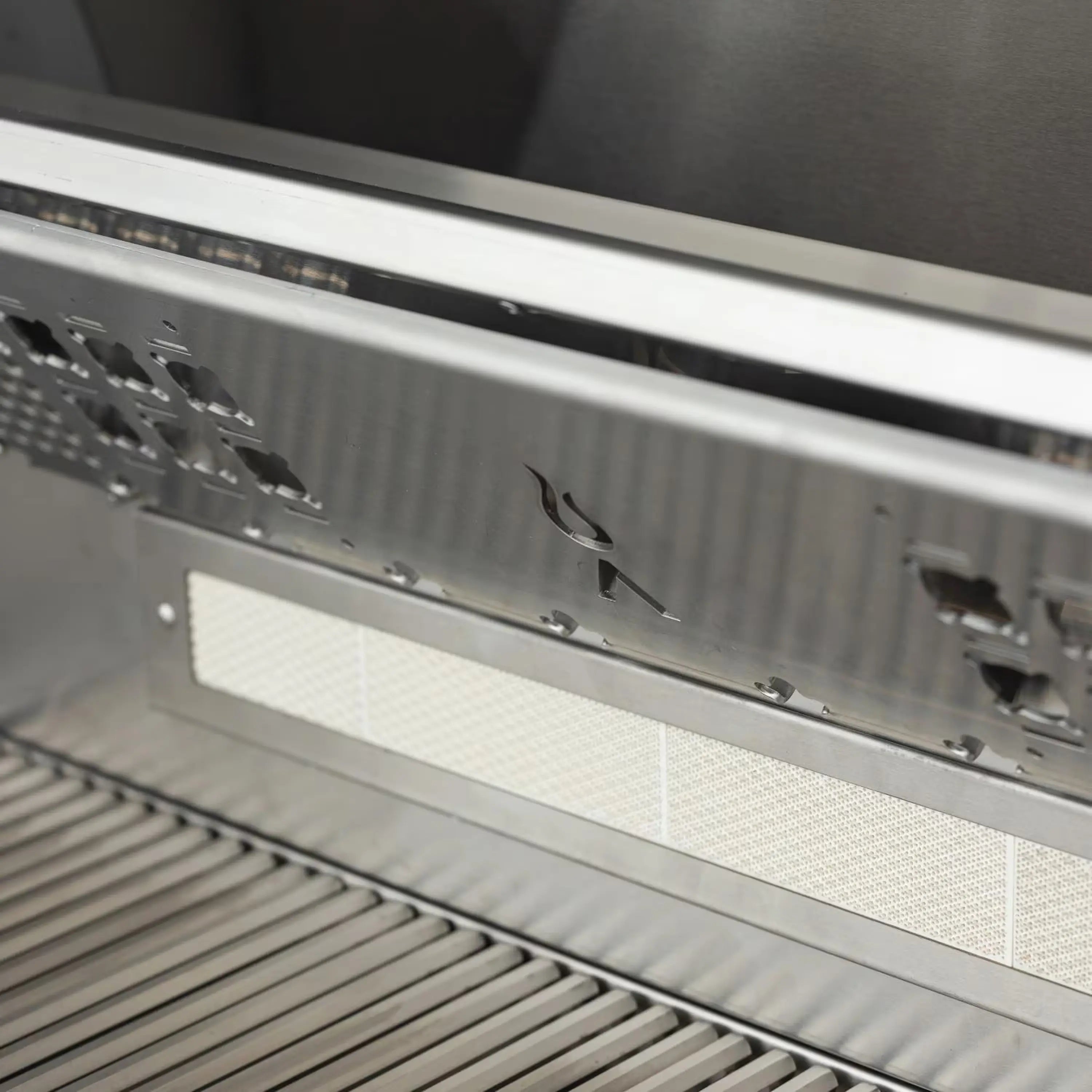 Open stainless grill interior with back infrared burner area and heat shield