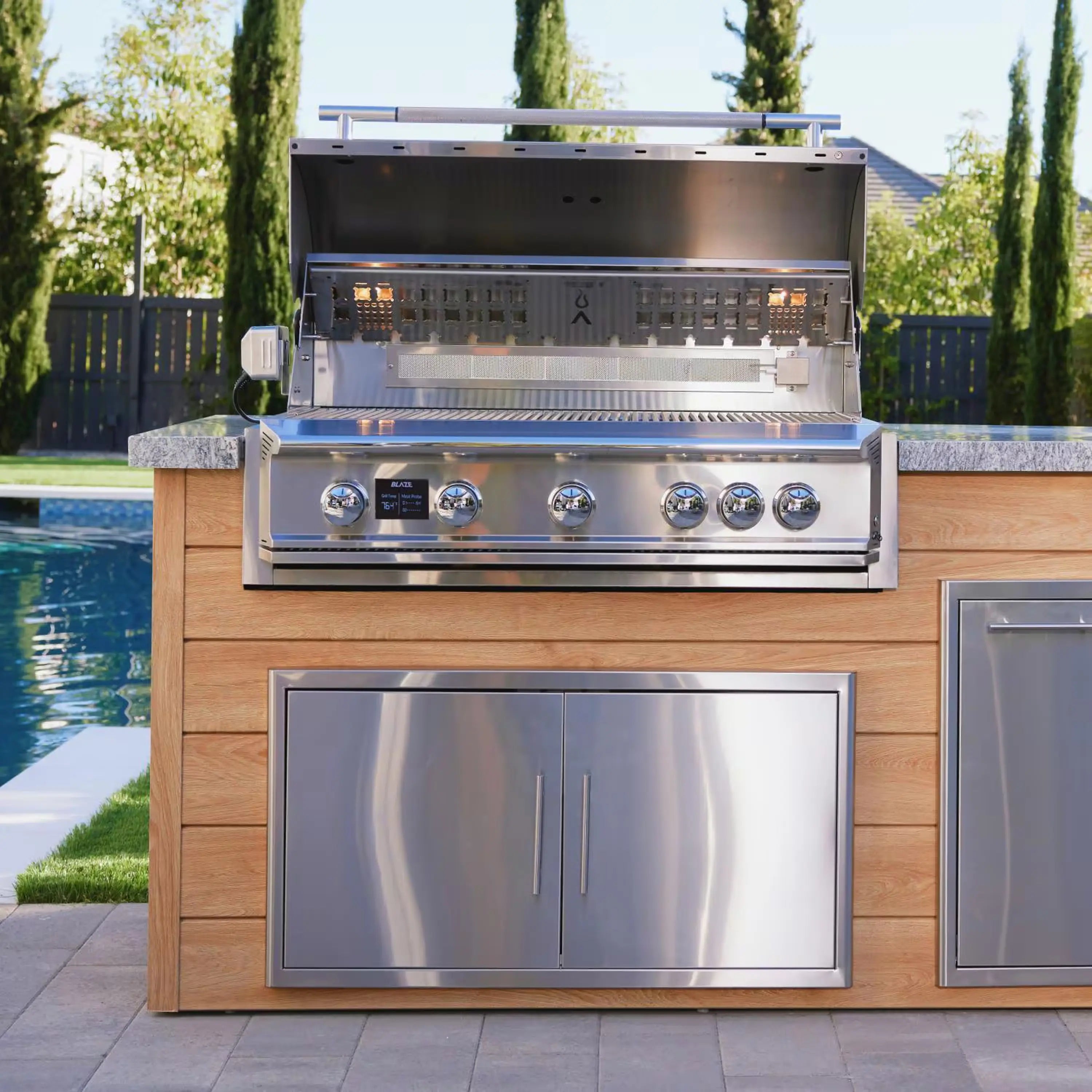 Built-in stainless 4-burner propane gas grill with control knobs and open hood