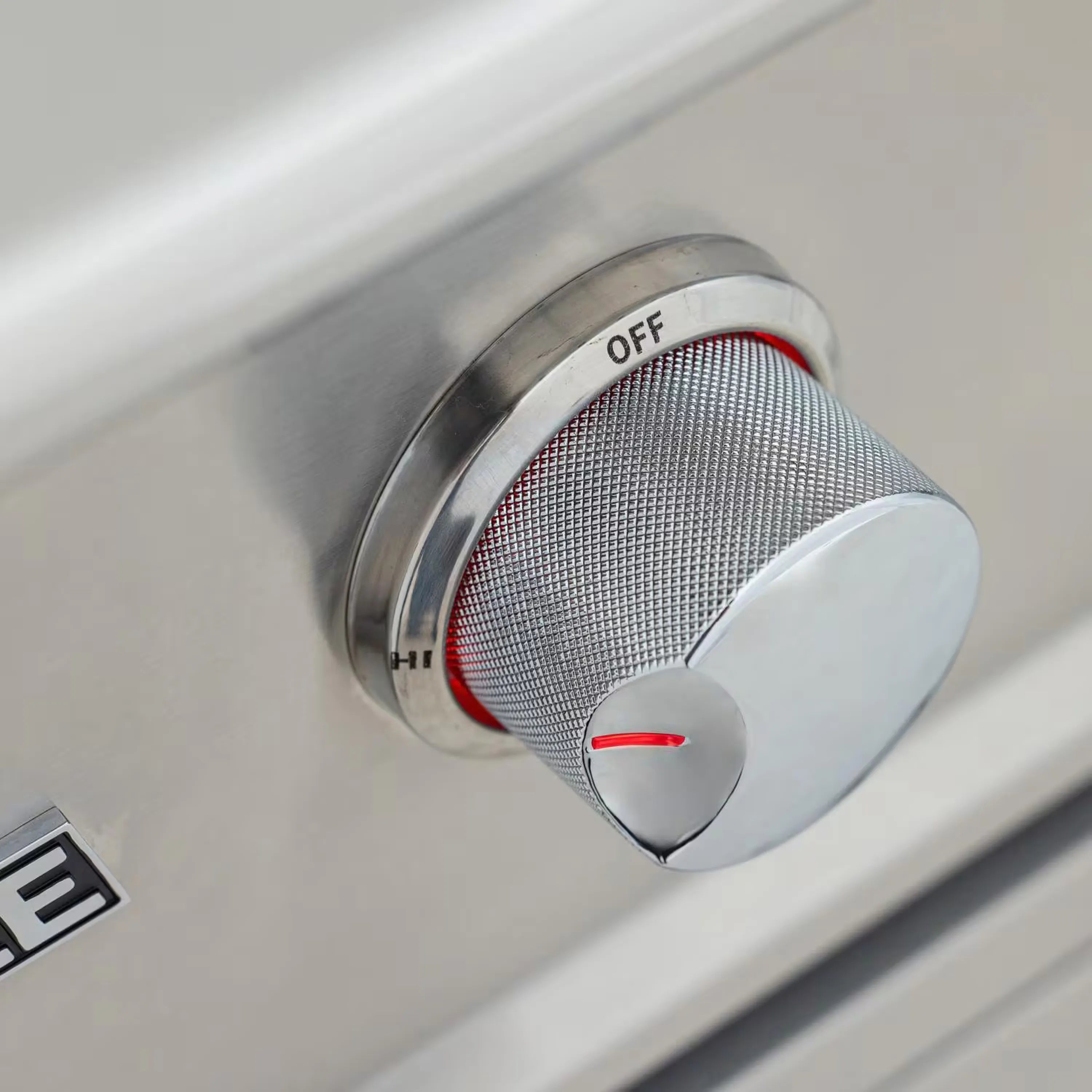 Gas griddle burner control knob with OFF label and red indicator mesh