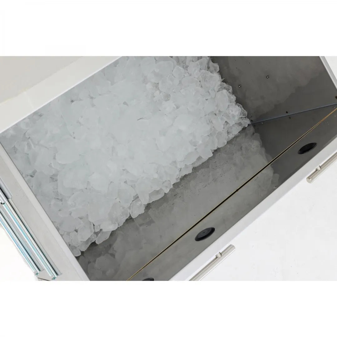 Insulated ice drawer open, filled with ice cubes, showing black drain holes