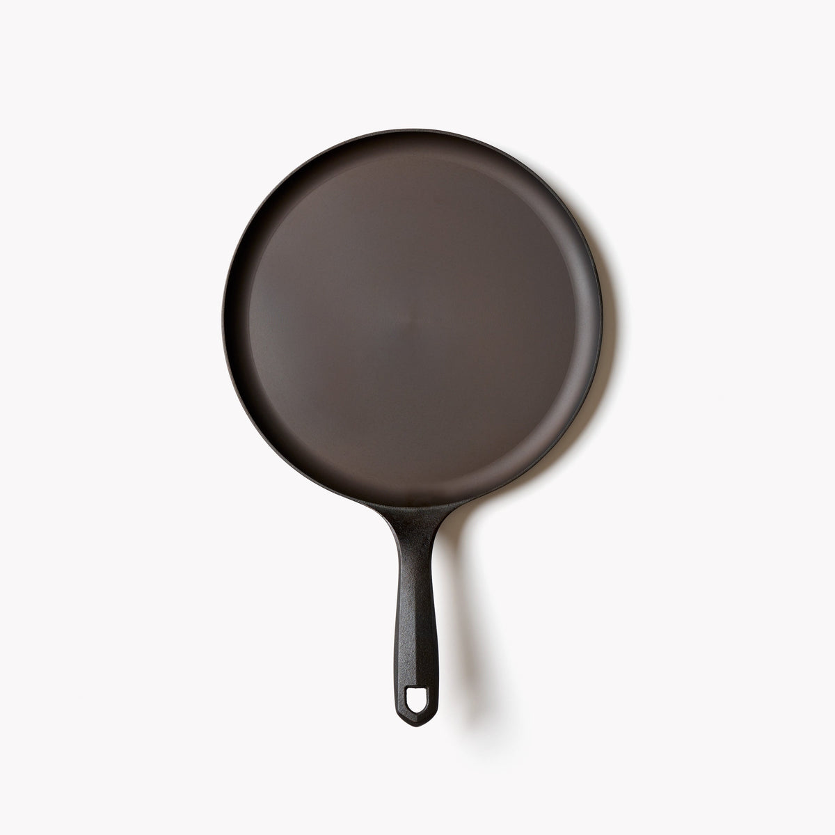 Round cast iron griddle base with loop handle, dark finish