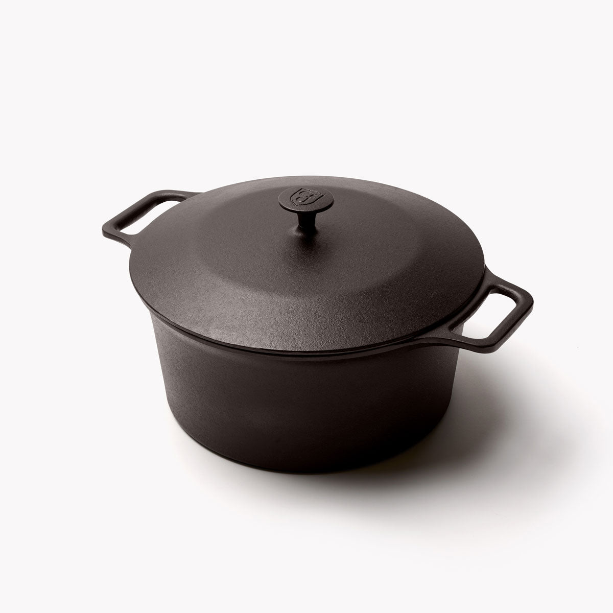 Black cast iron Dutch oven with lid knob and two side handles