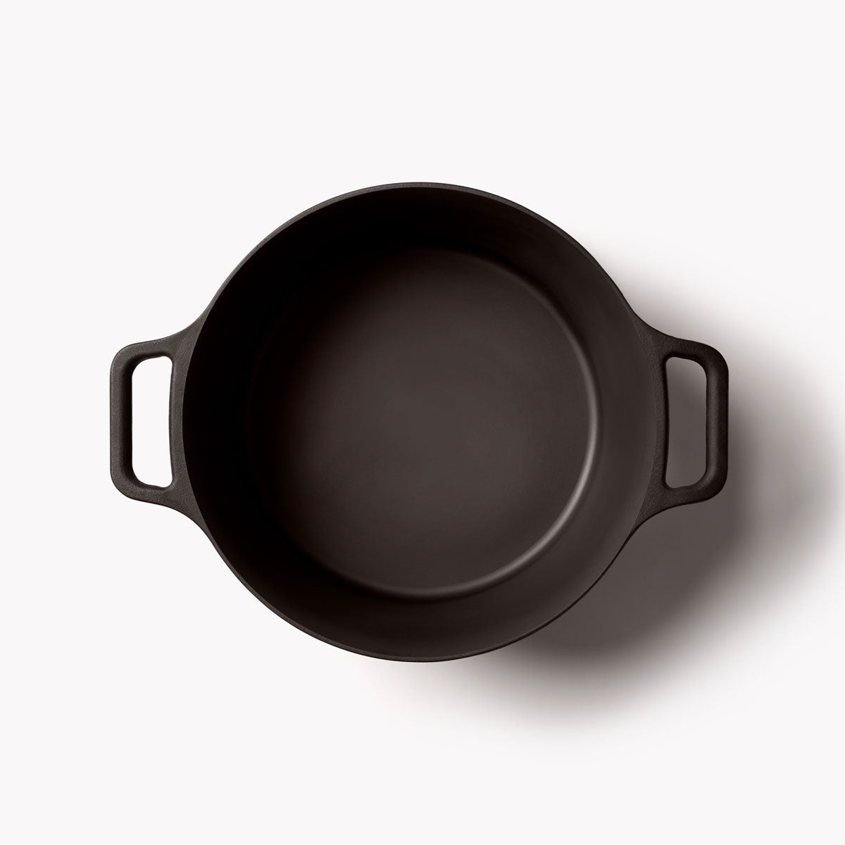Black cast iron Dutch oven interior with two side handles