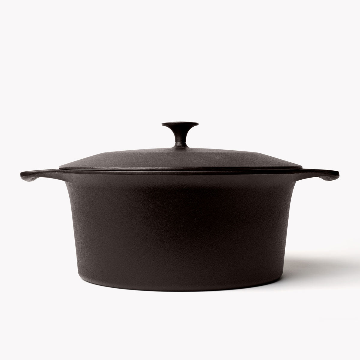 Black cast iron Dutch oven with matching lid and loop side handles