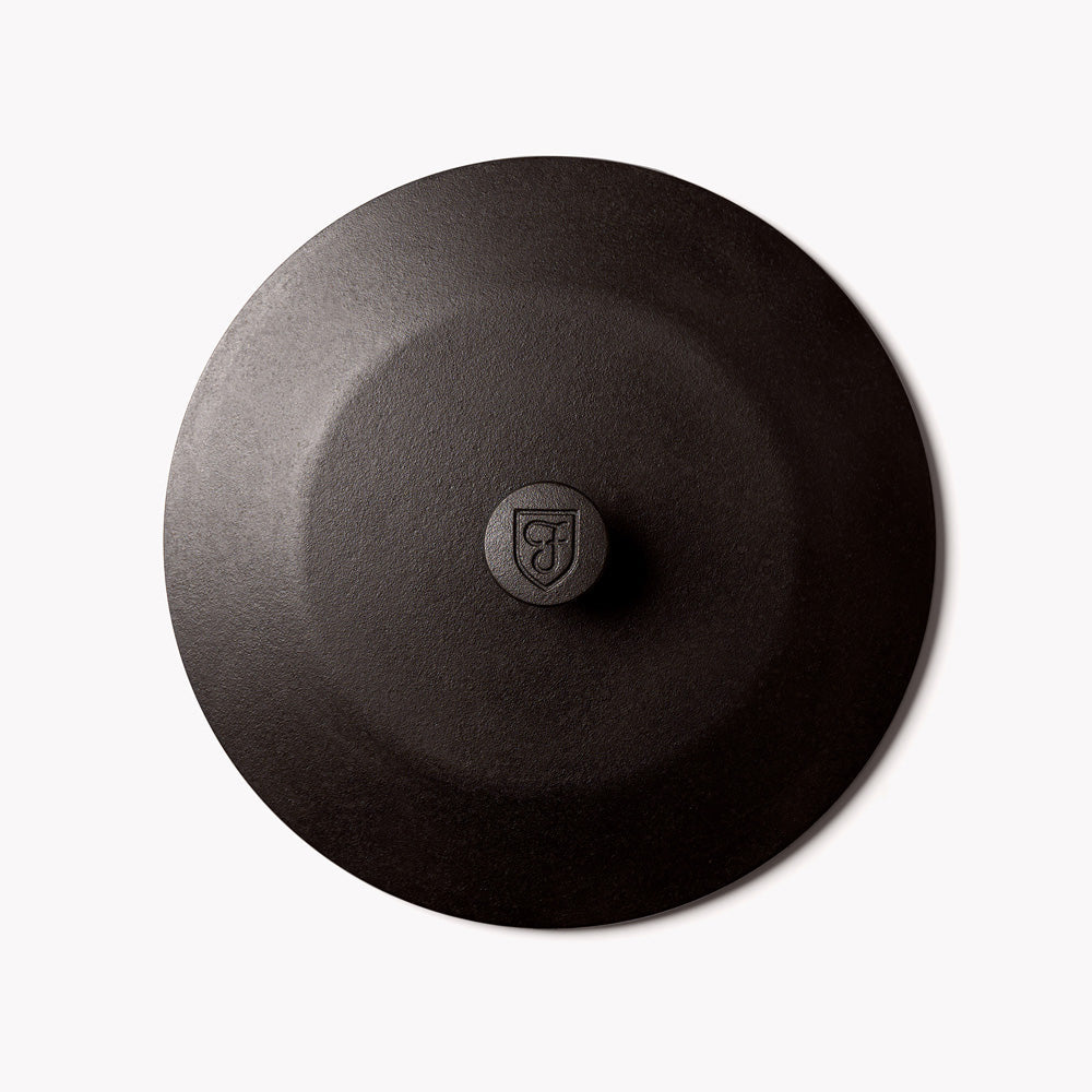 Cast iron skillet lid, dark charcoal, round with central knob and raised rim