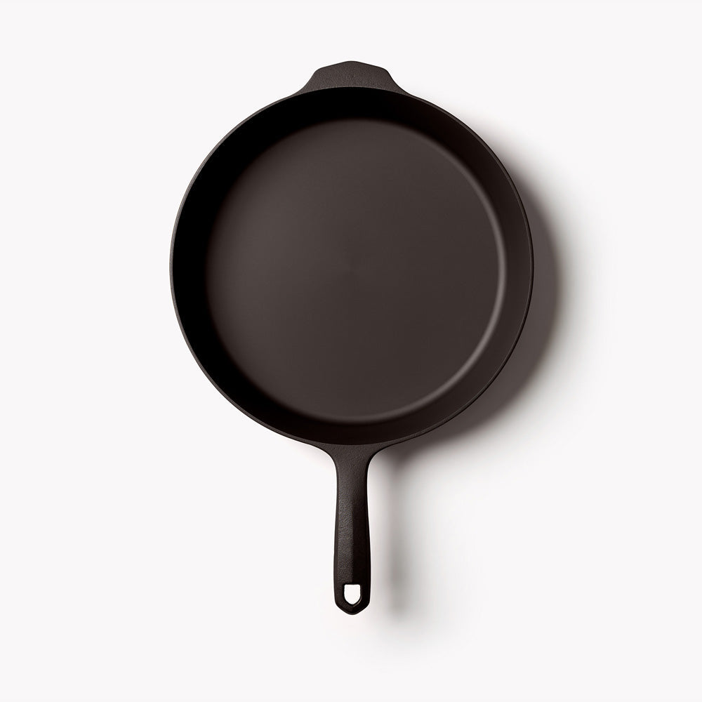 Dark cast-iron skillet with loop handle, 10 11 ⅝-inch round pan