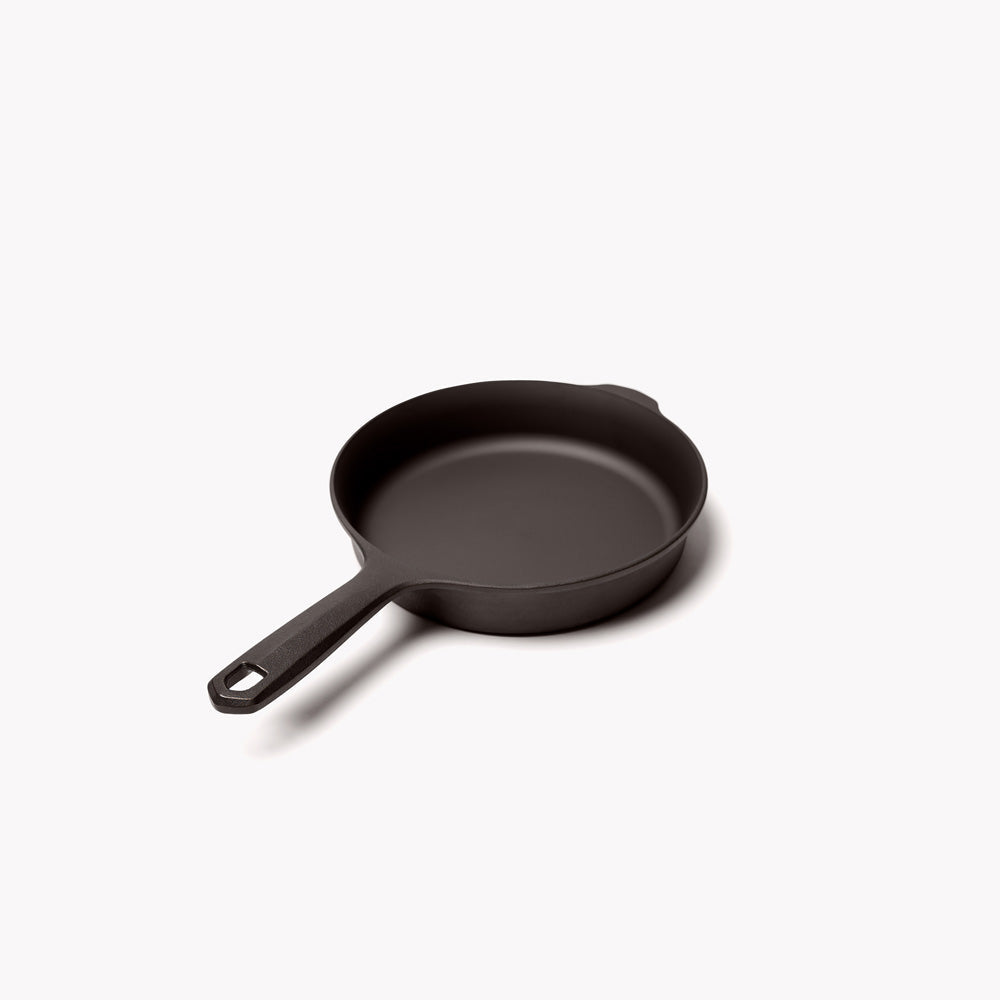 Cast iron skillet with short handle and pouring lip, black finish, empty cooking pan