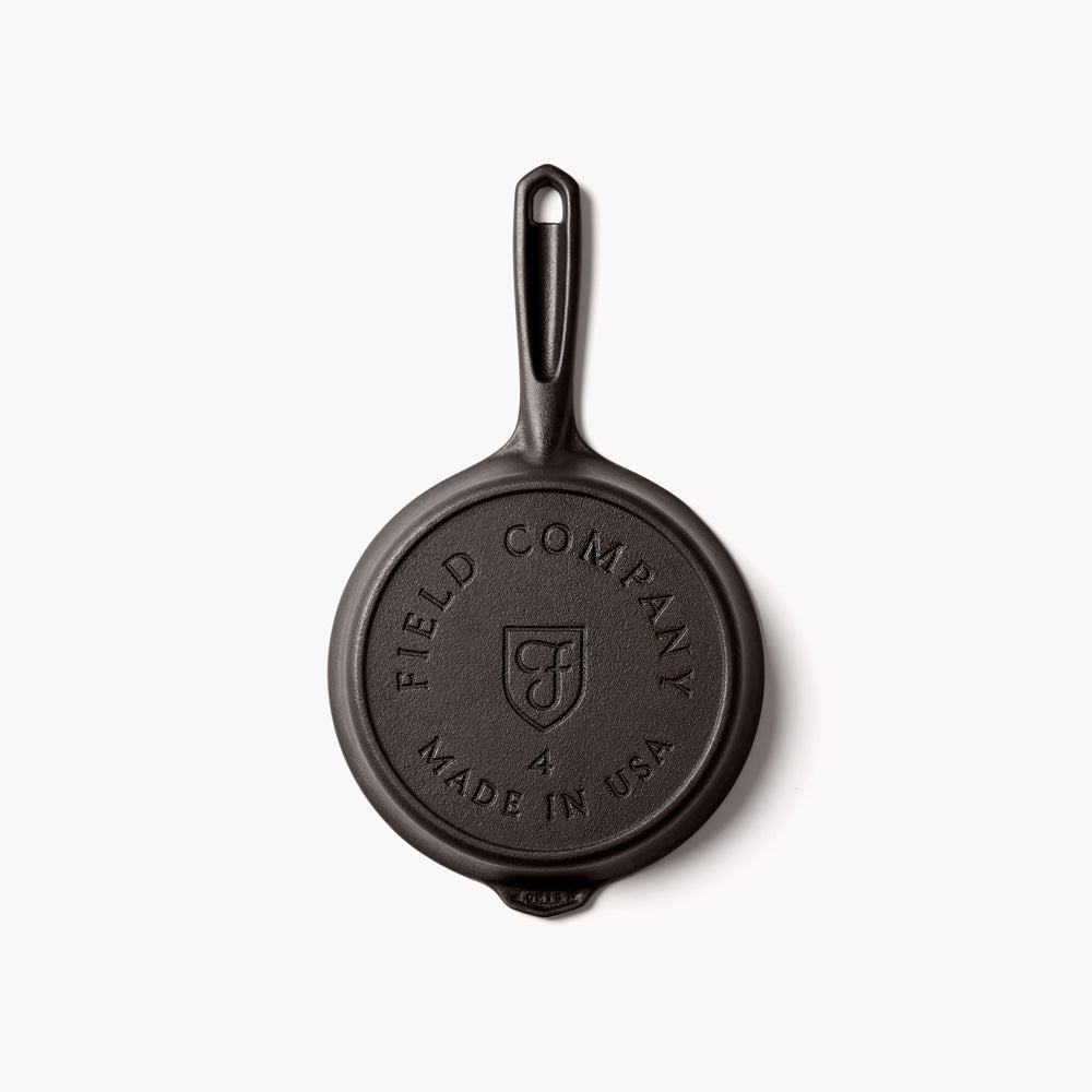 Cast iron skillet base stamp: FIELD COMPANY and MADE IN USA, with side handle