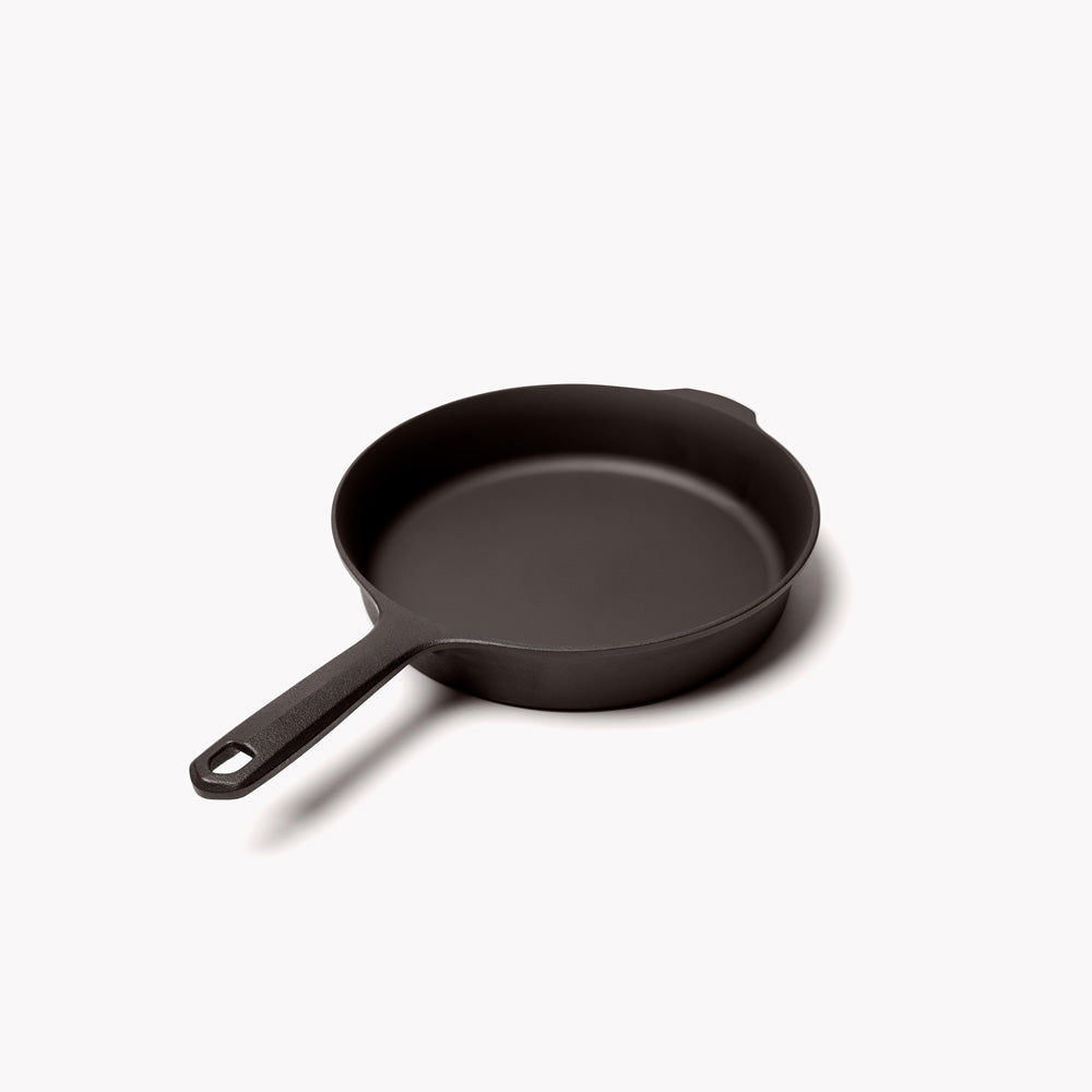 Black cast iron skillet with long handle, empty interior