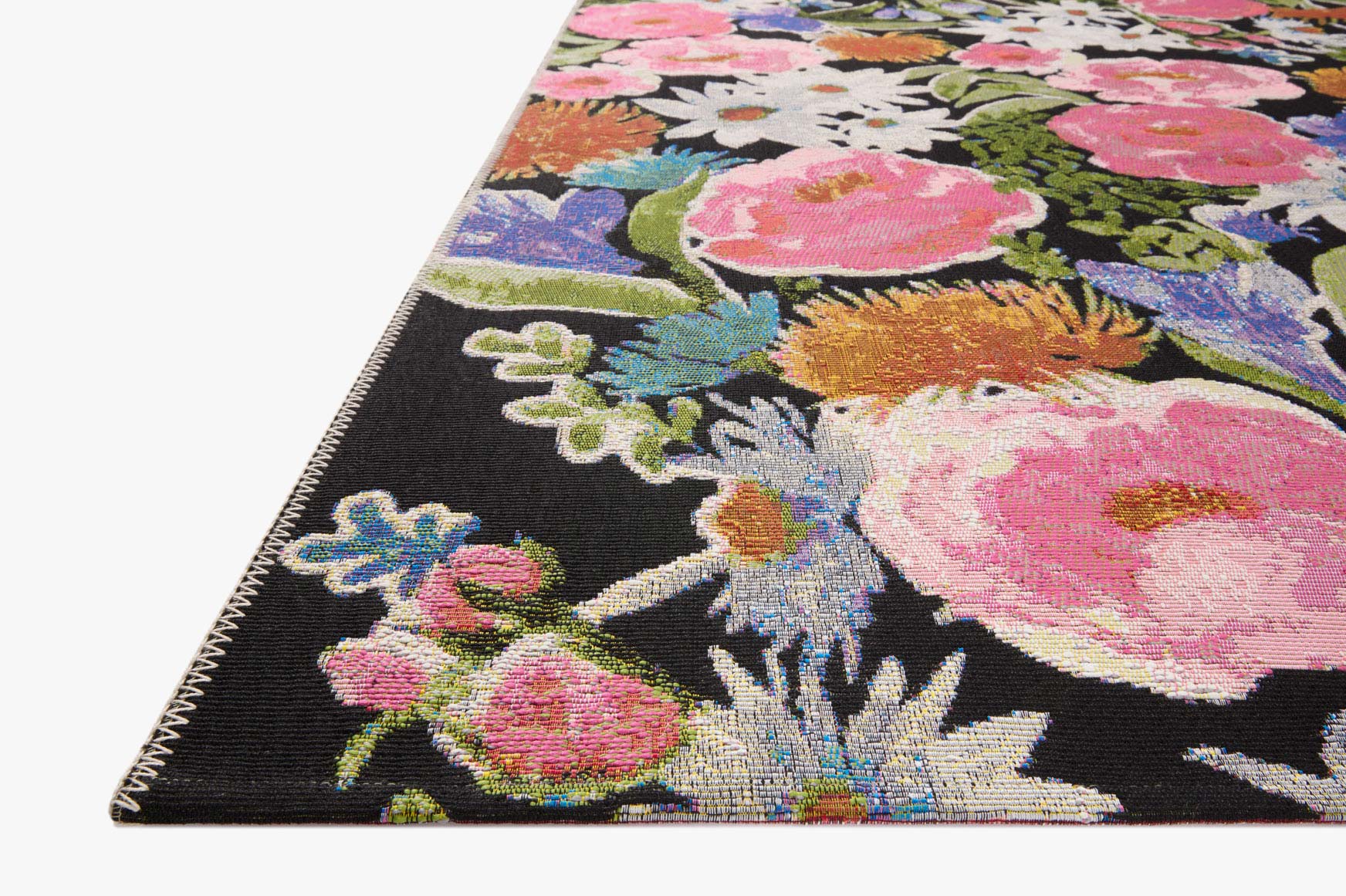 Floral accent rug with multicolor blossoms on a dark background, stitched border corner.