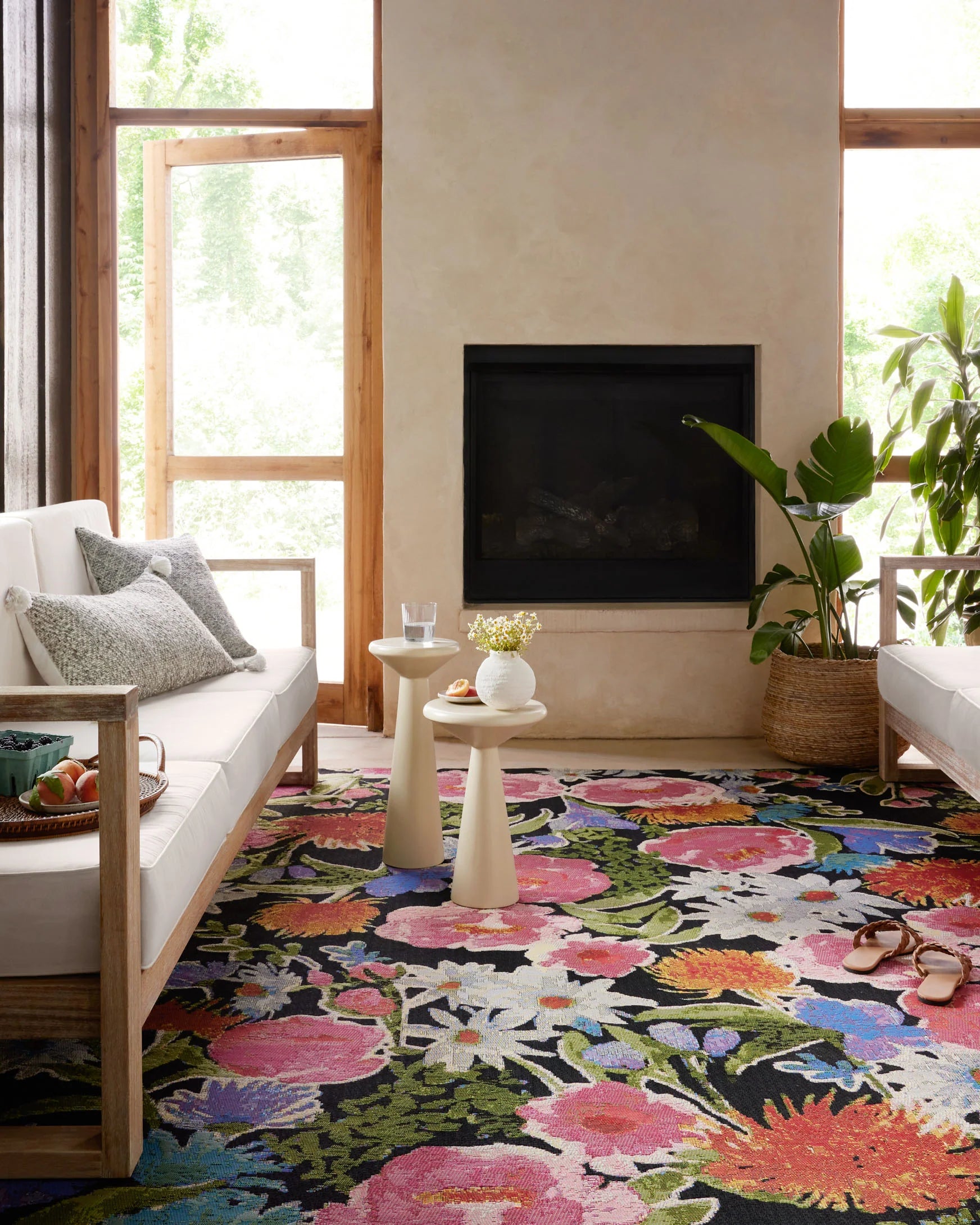 Floral indoor/outdoor area rug with colorful blossoms on a dark background