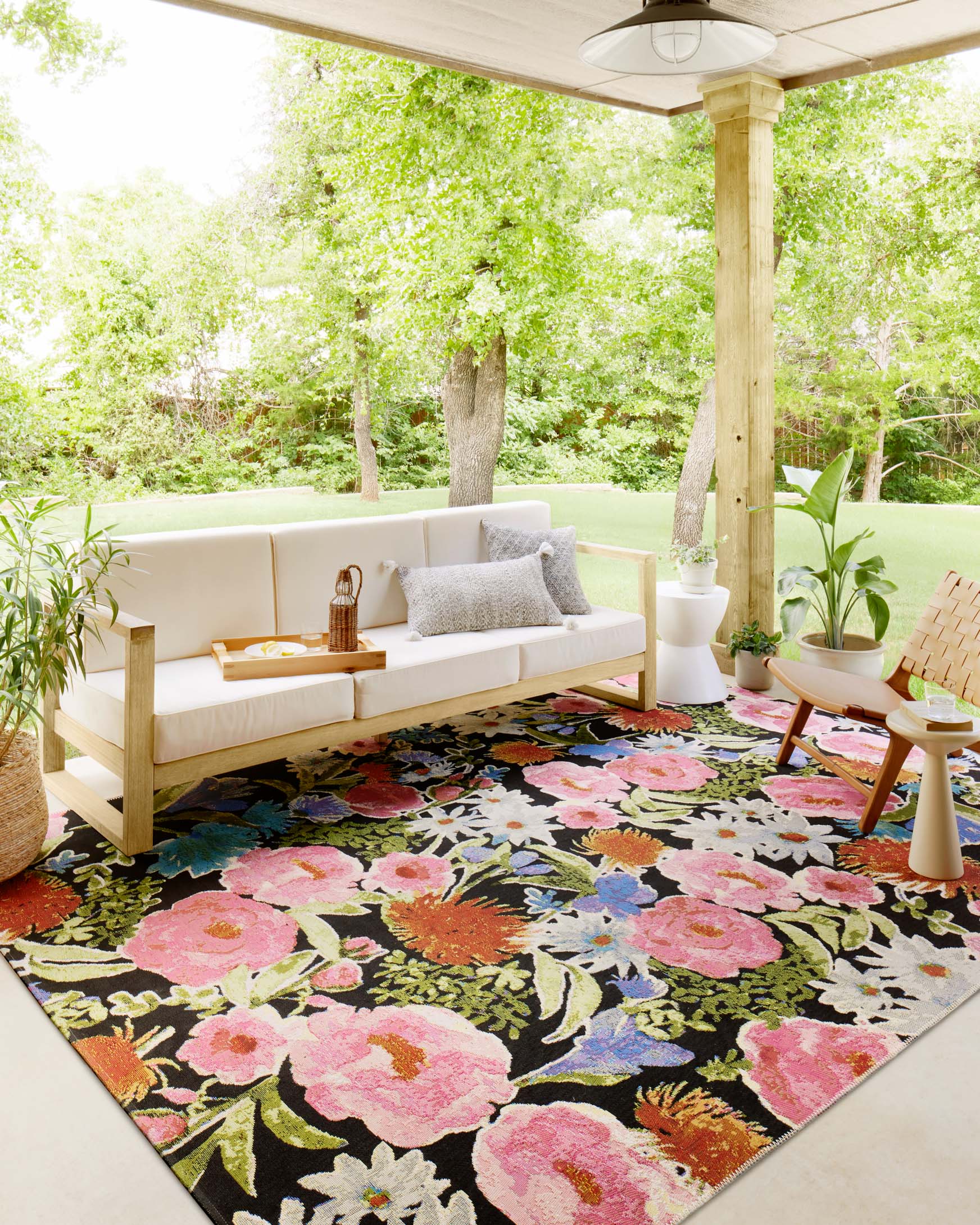Botanical runner rug with vivid pink, orange, blue, and green flowers on dark background