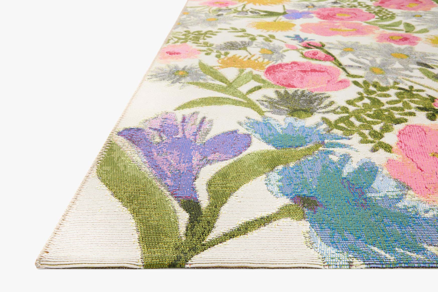 Floral accent rug with off-white background and colorful blossoms, angled view