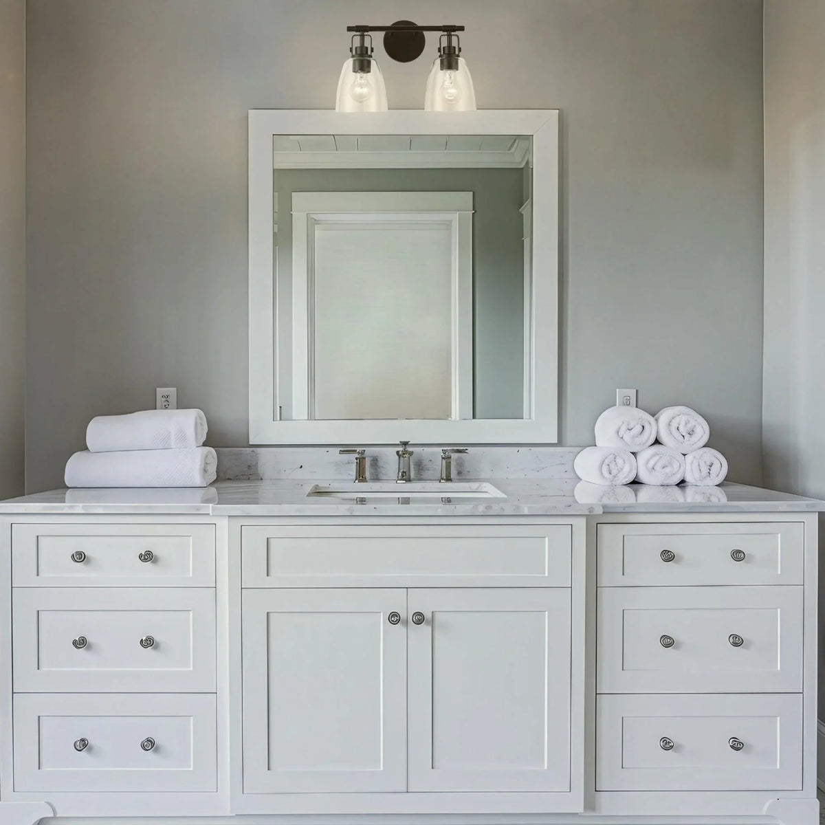 Black 2-light vanity light with two frosted glass shades and arched backplate.