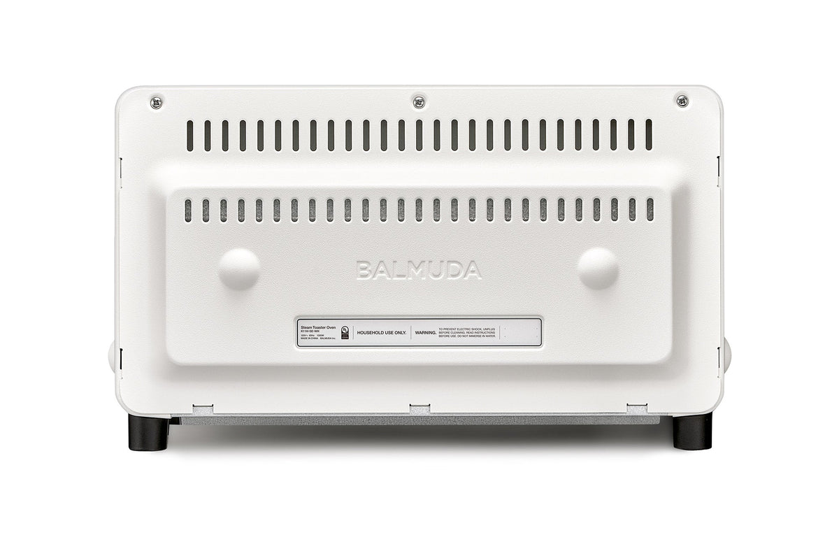 Off-white countertop toaster oven back panel with ventilation slots and BALMUDA label