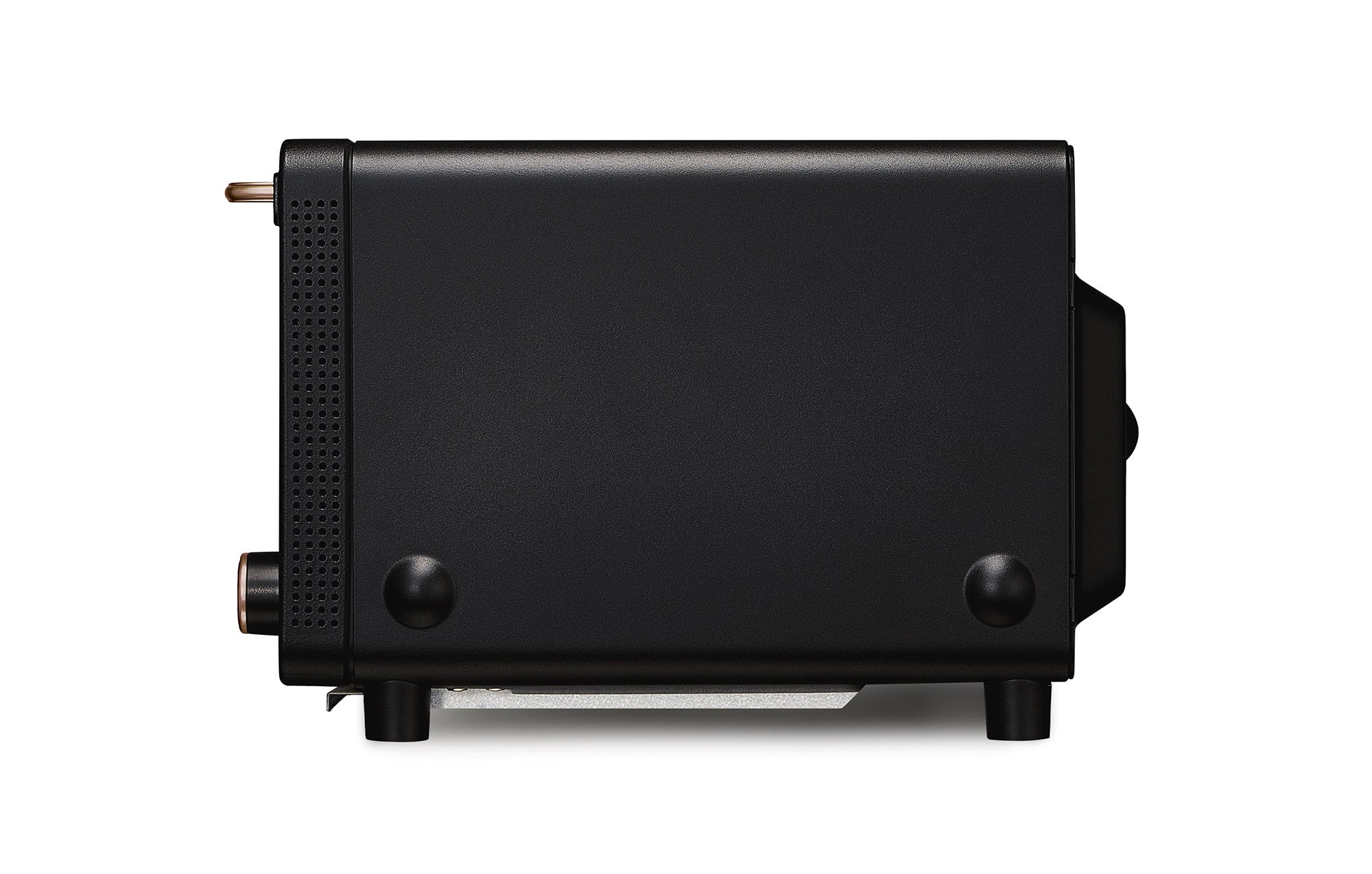 Black countertop toaster oven from the side with control knobs and vented side panel