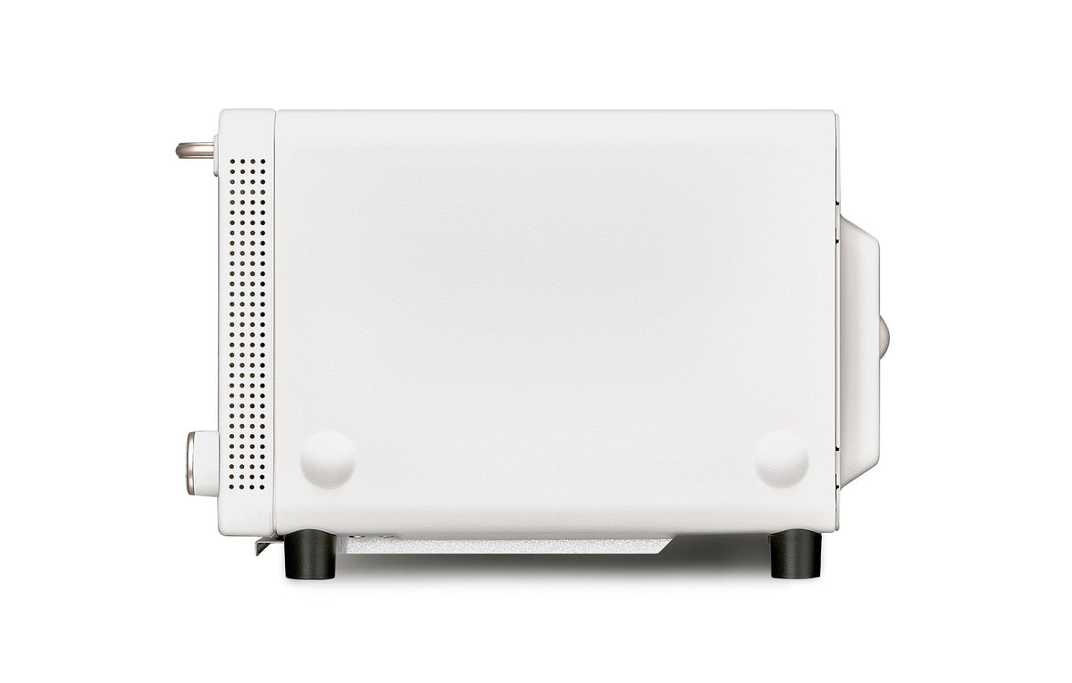 Off-white countertop toaster oven side view with control knobs and vented side panel