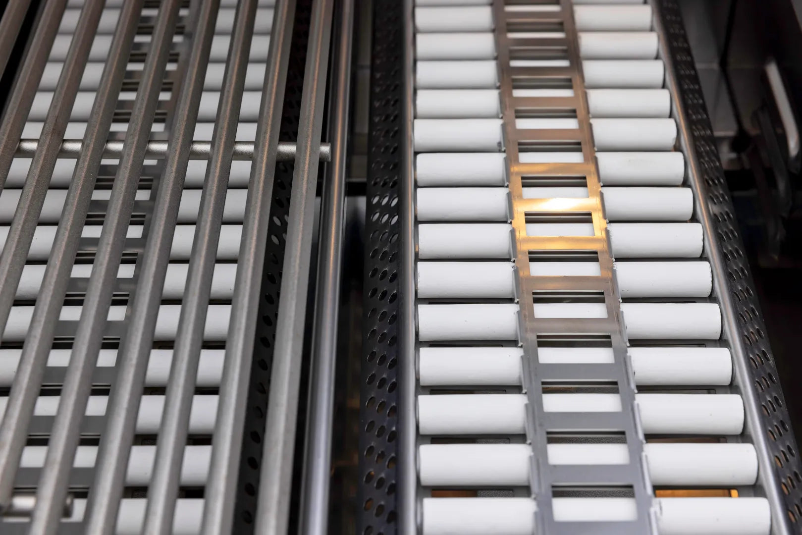 Ceramic tube insert with white cylinders flanked by dark metal heat shields