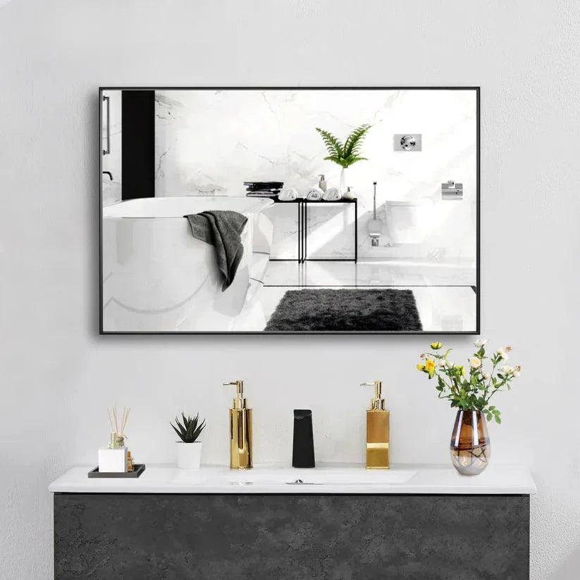 Rectangular wall mirror with black frame reflecting bathroom vanity decor