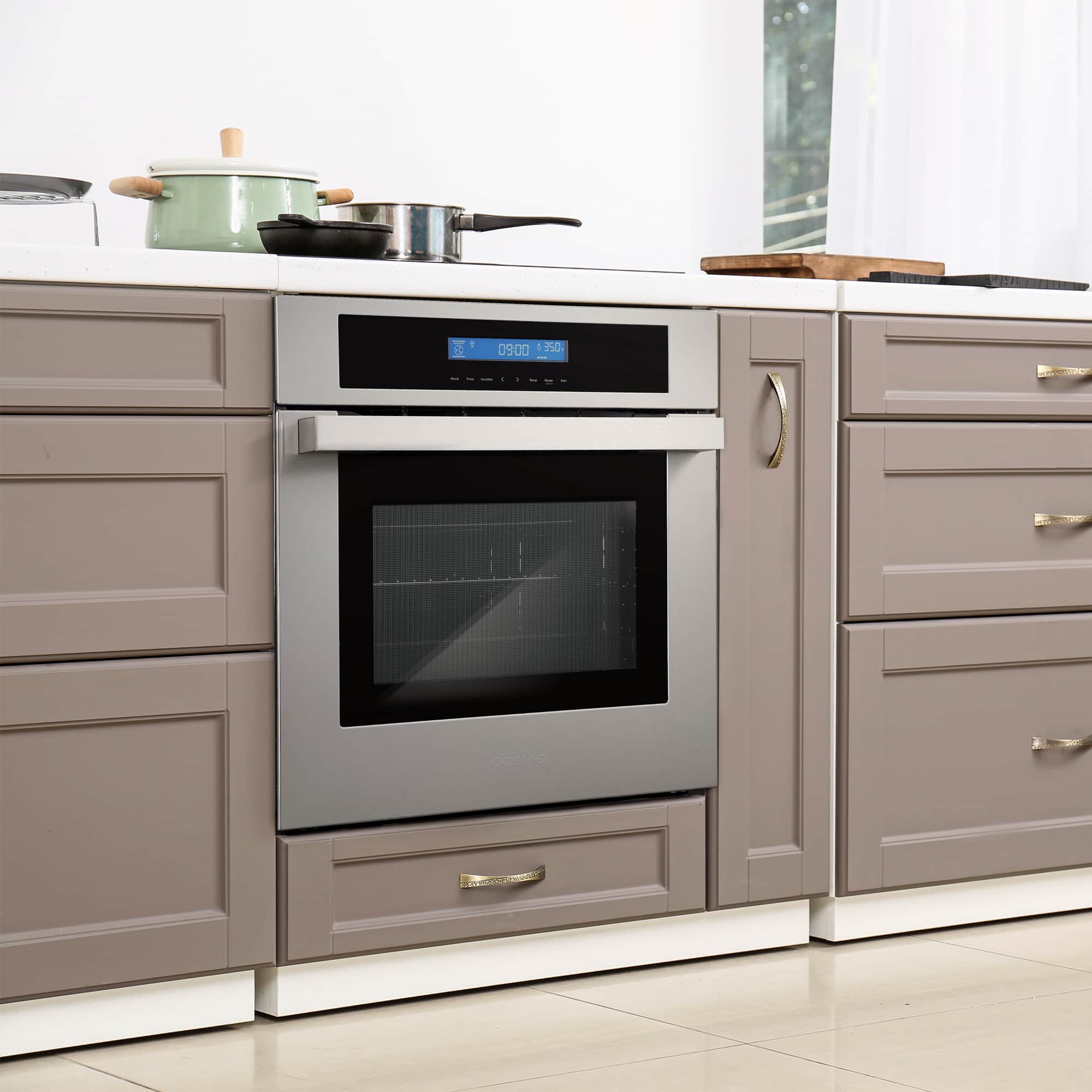 Stainless steel electric wall oven centered in cabinetry with black glass door