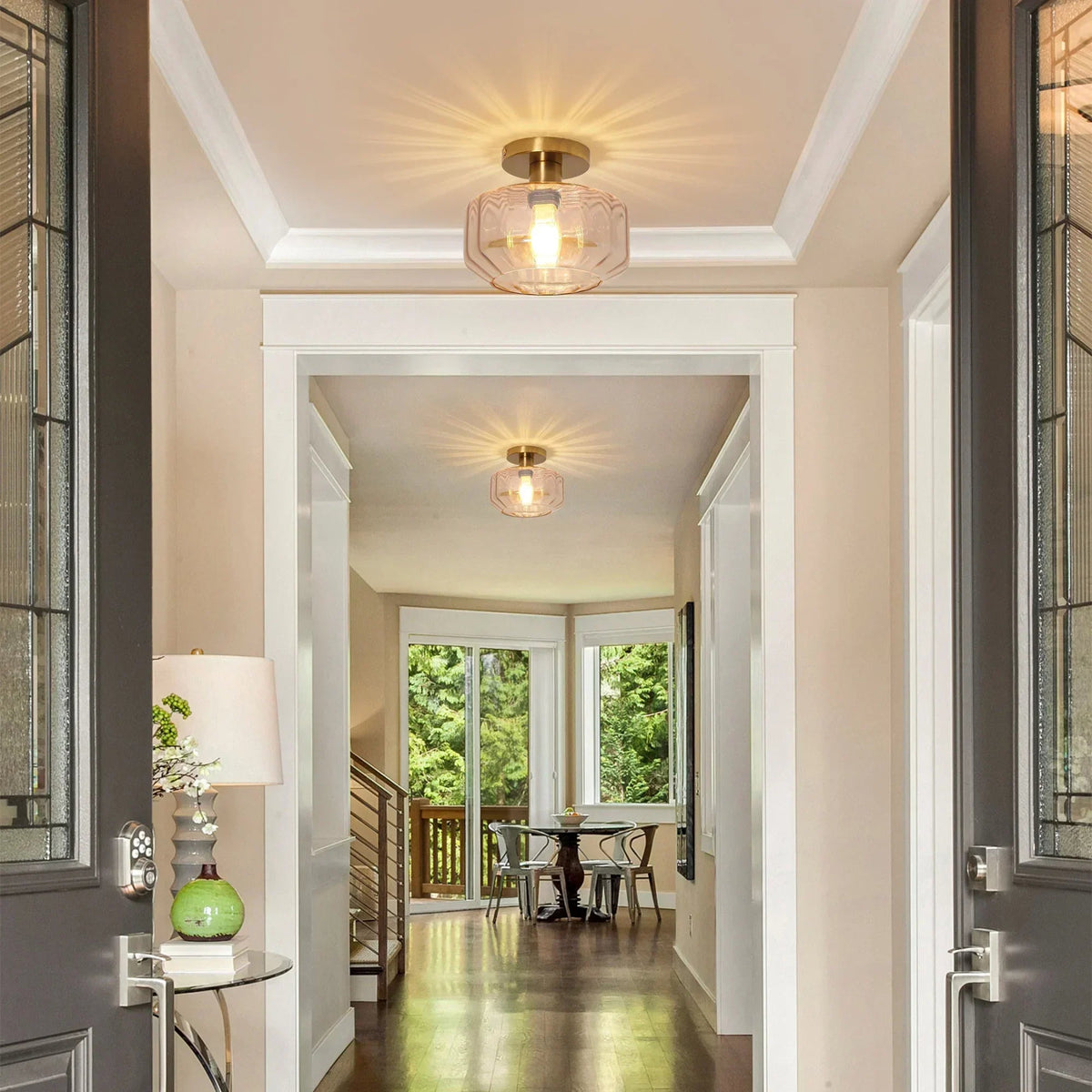 Golden semi-flush ceiling lights with clear glass shades and exposed bulbs in a hallway