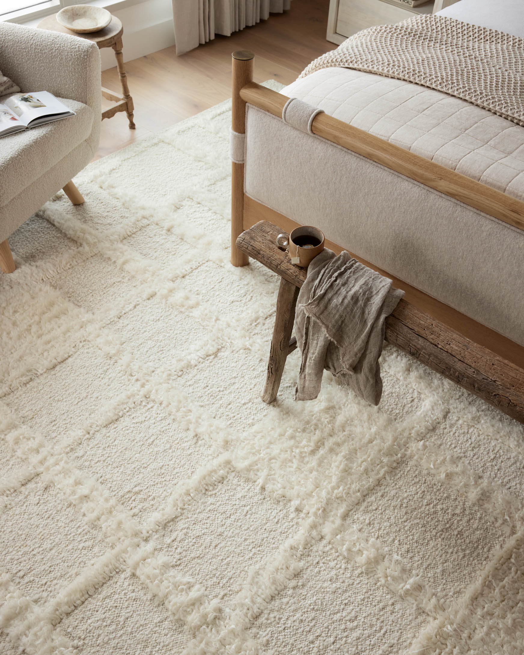 Ivory shag area rug with dense textured pile and softly mottled pattern