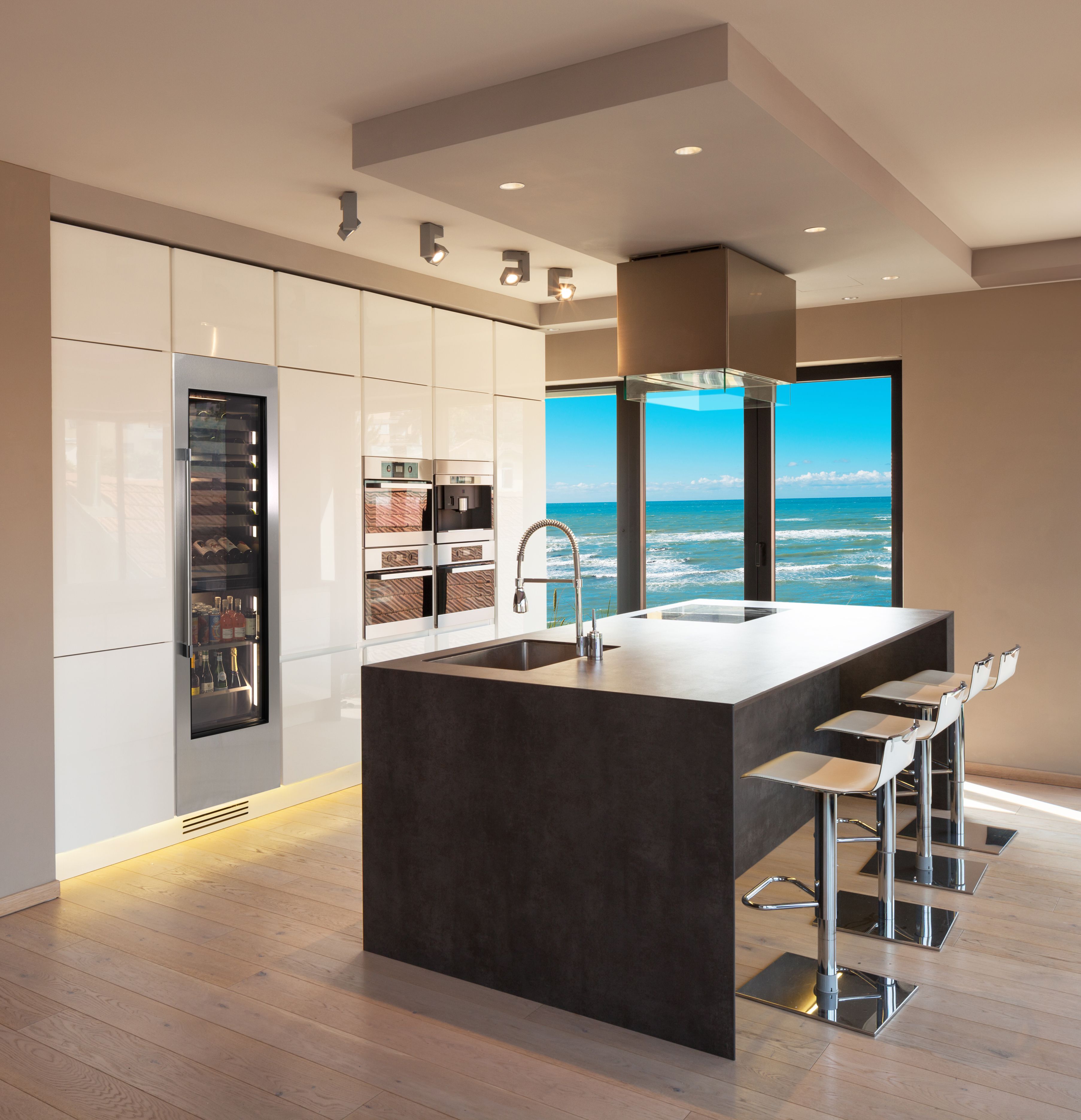 Built-in dual-zone beverage center with glass door and stainless trim, black cabinet