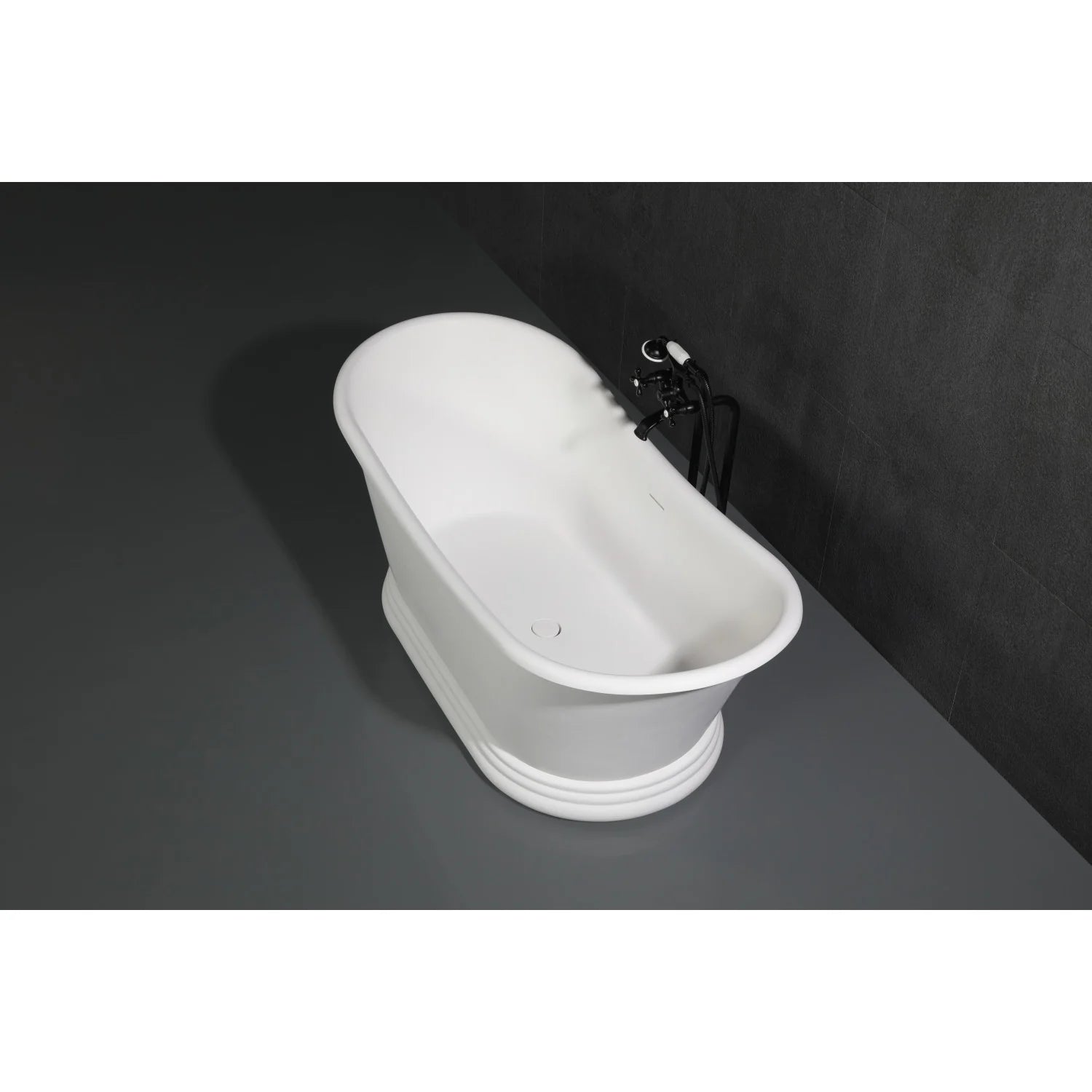 Matte black freestanding tub faucet with curved spout and handles on a white oval tub
