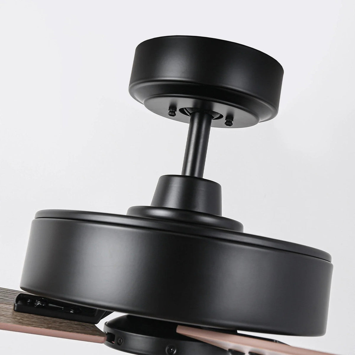 Black ceiling fan close-up with wood-tone blade and motor assembly