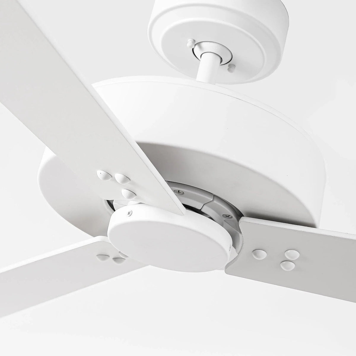 White ceiling fan showing motor housing and blade attachment close-up